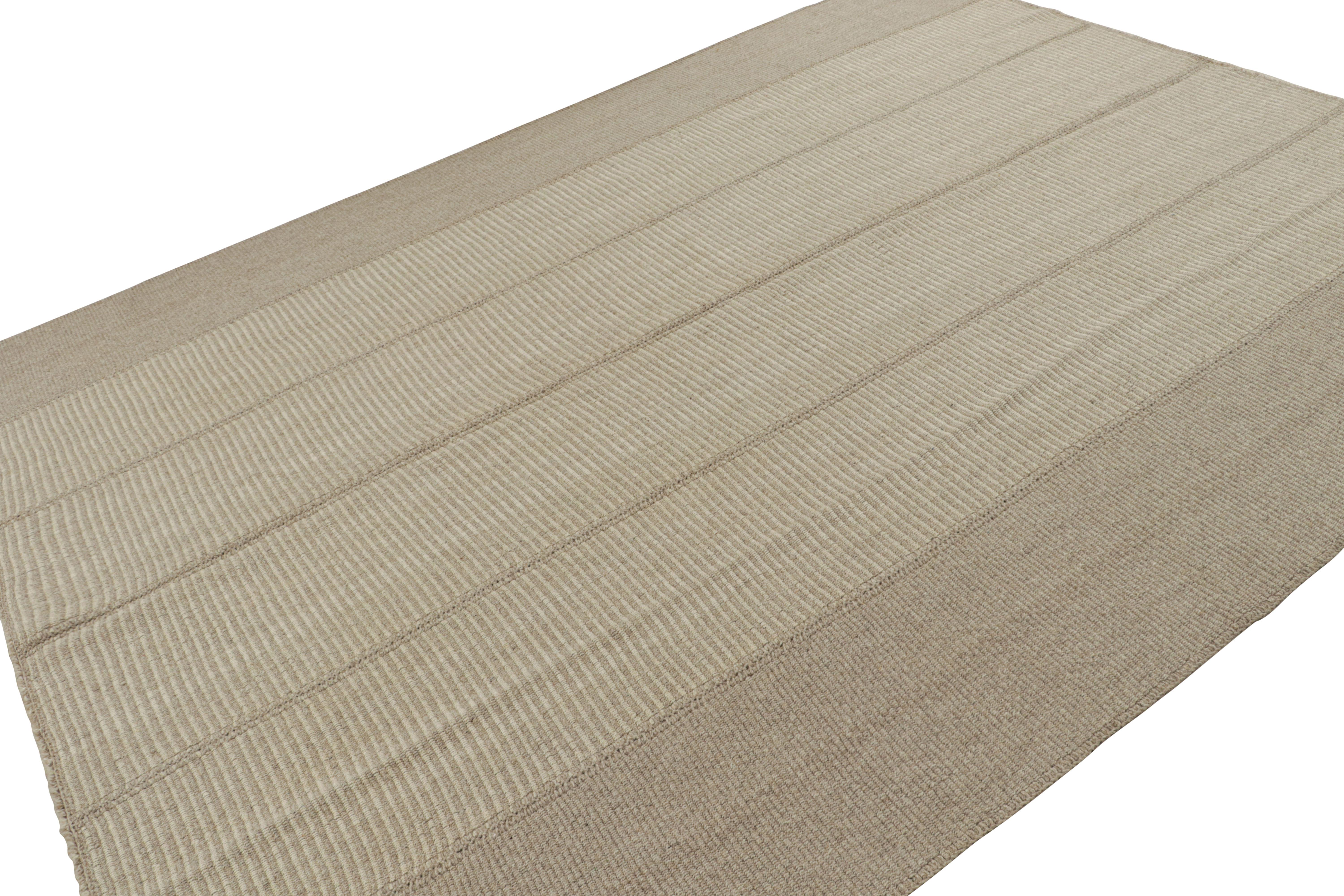 Handwoven in wool, a 9×12 Kilim with beige and brown textural stripes, from a bold new line of contemporary flatweaves, ‘Rez Kilim’, by Rug & Kilim.

On the design:  

Connoting a modern take on classic panel-weaving, our latest “Rez Kilim” enjoys