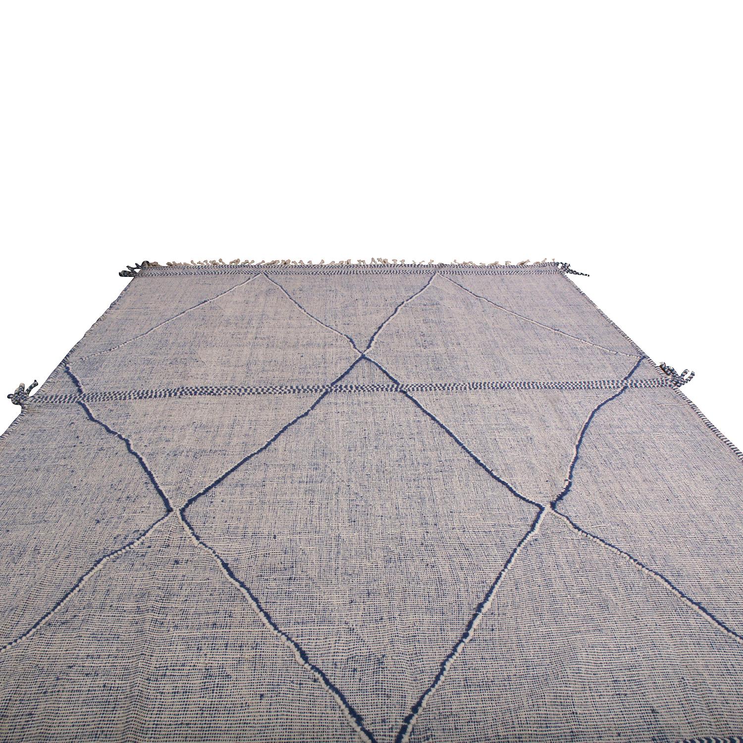 This addition to Rug & Kilim’s extensive contemporary and modern rug collection recaptures the inspiration of a classic Moroccan Berber rug in new large-scale and textural high-low production. The thick braiding at the playful fringes, borders and