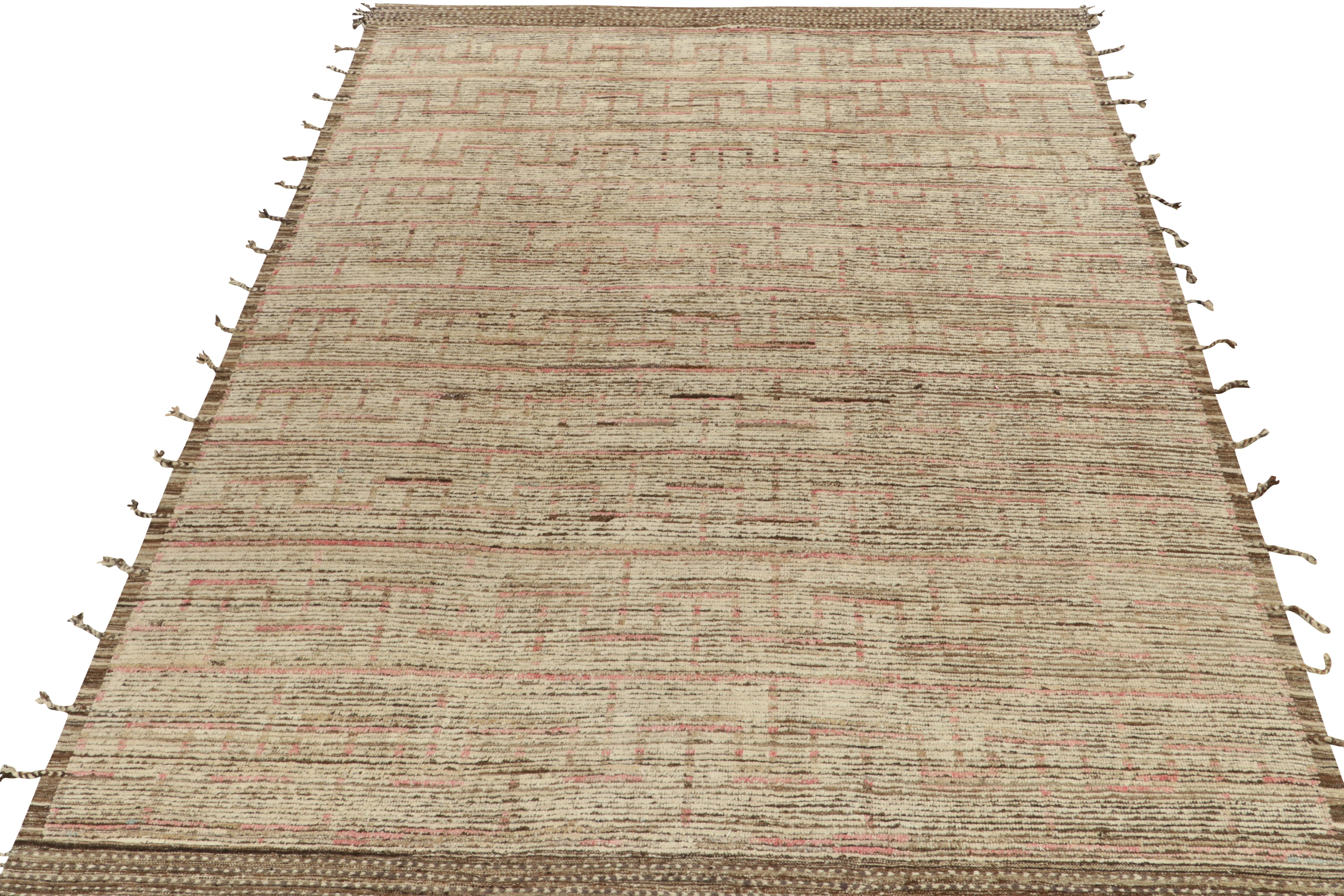 Rug & Kilim draws an alluring spin on Moroccan style with this 9x13 hand-knotted piece. The gracious piece enjoys a comfortable high low appeal in creamy white, brown & pink tones concluding to fringes on the borders for amplified dimensionality to