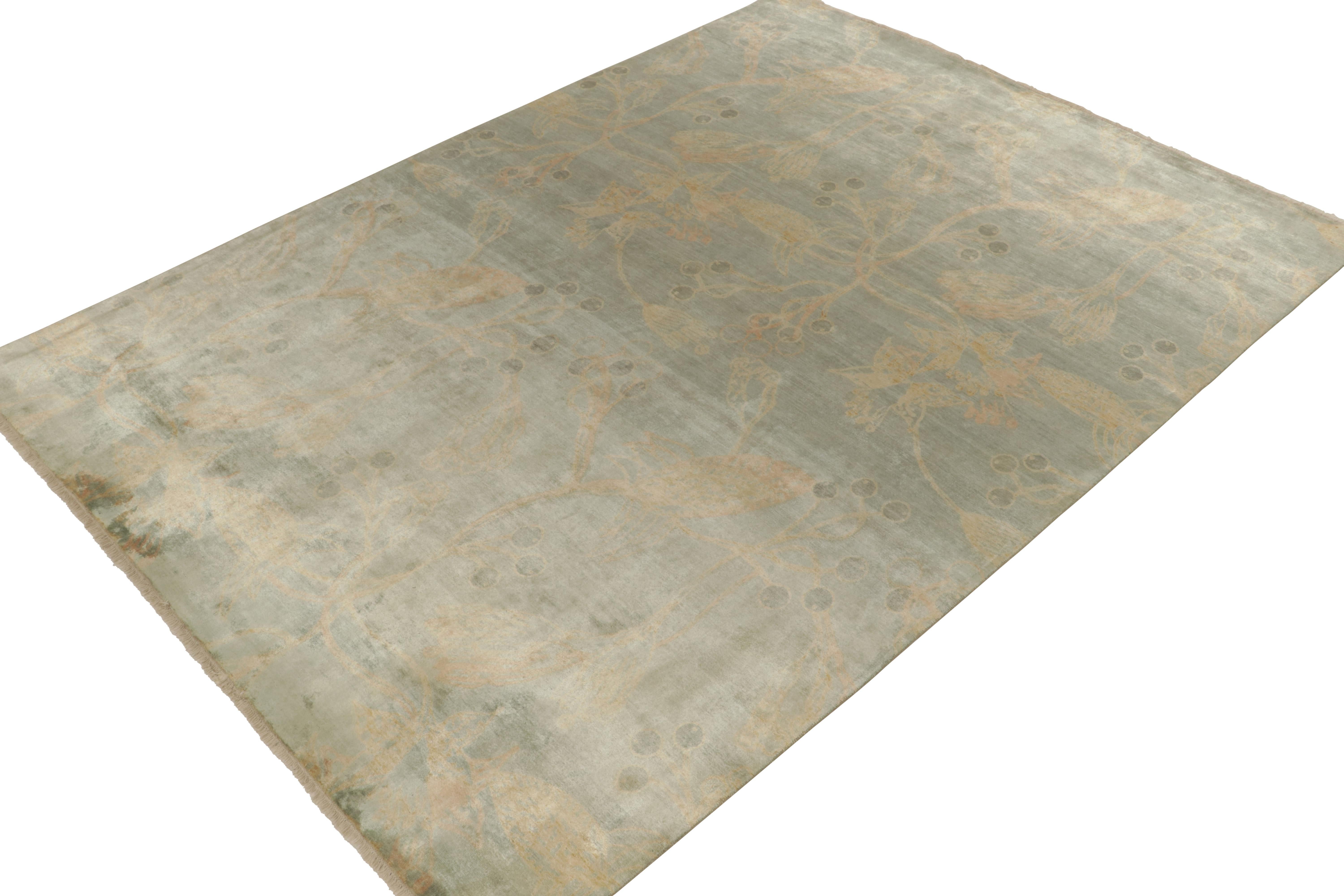 Hand-knotted in silk, this 9x12 contemporary rug from our Modern Classics collection boasts a delicious take on European sensibilities. 

A transitional inspiration marks a gorgeous floral pattern in gold tones atop the most atypical, teal-trending