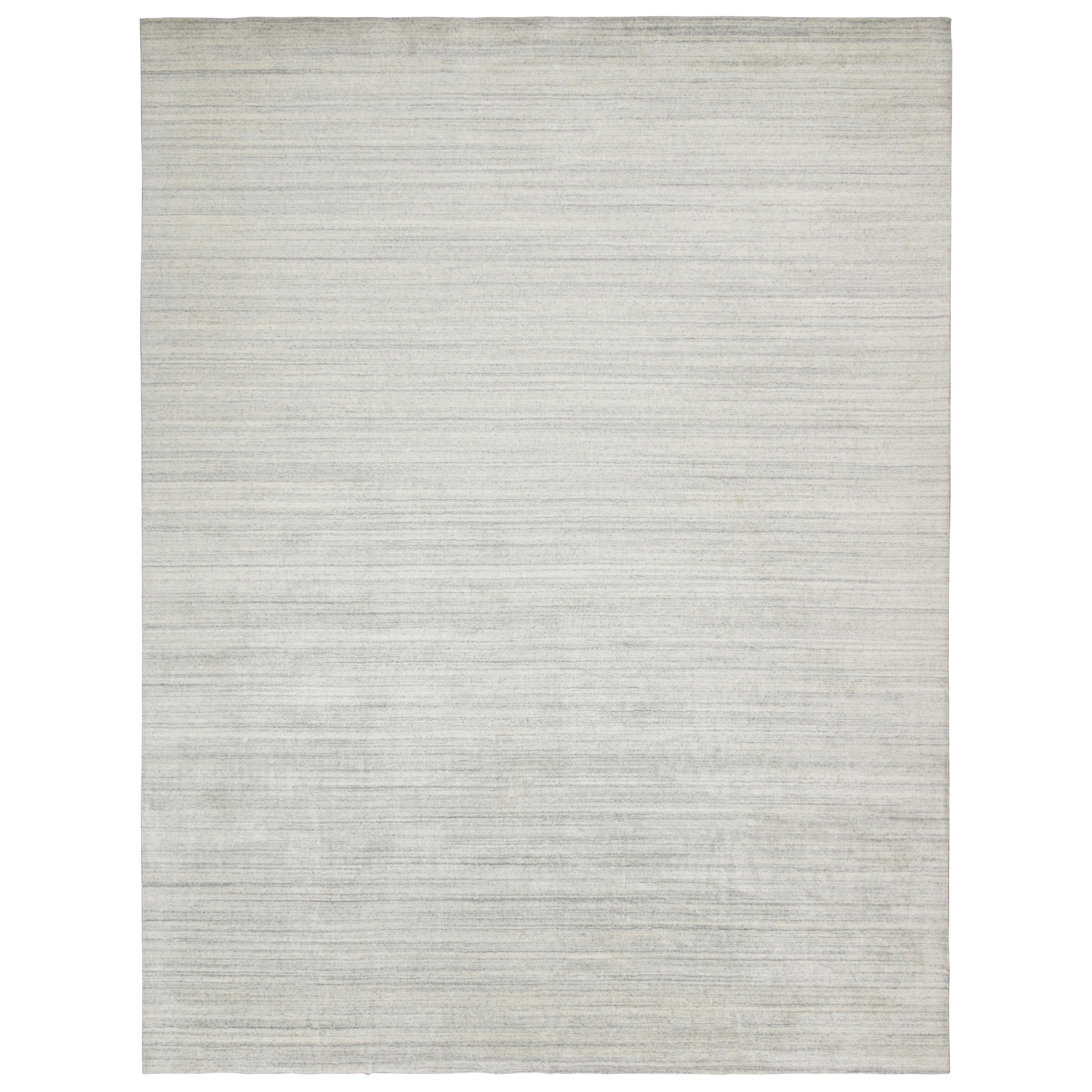 Rug & Kilim è un tappeto contemporaneo a strisce argento, bianco sporco e blu.