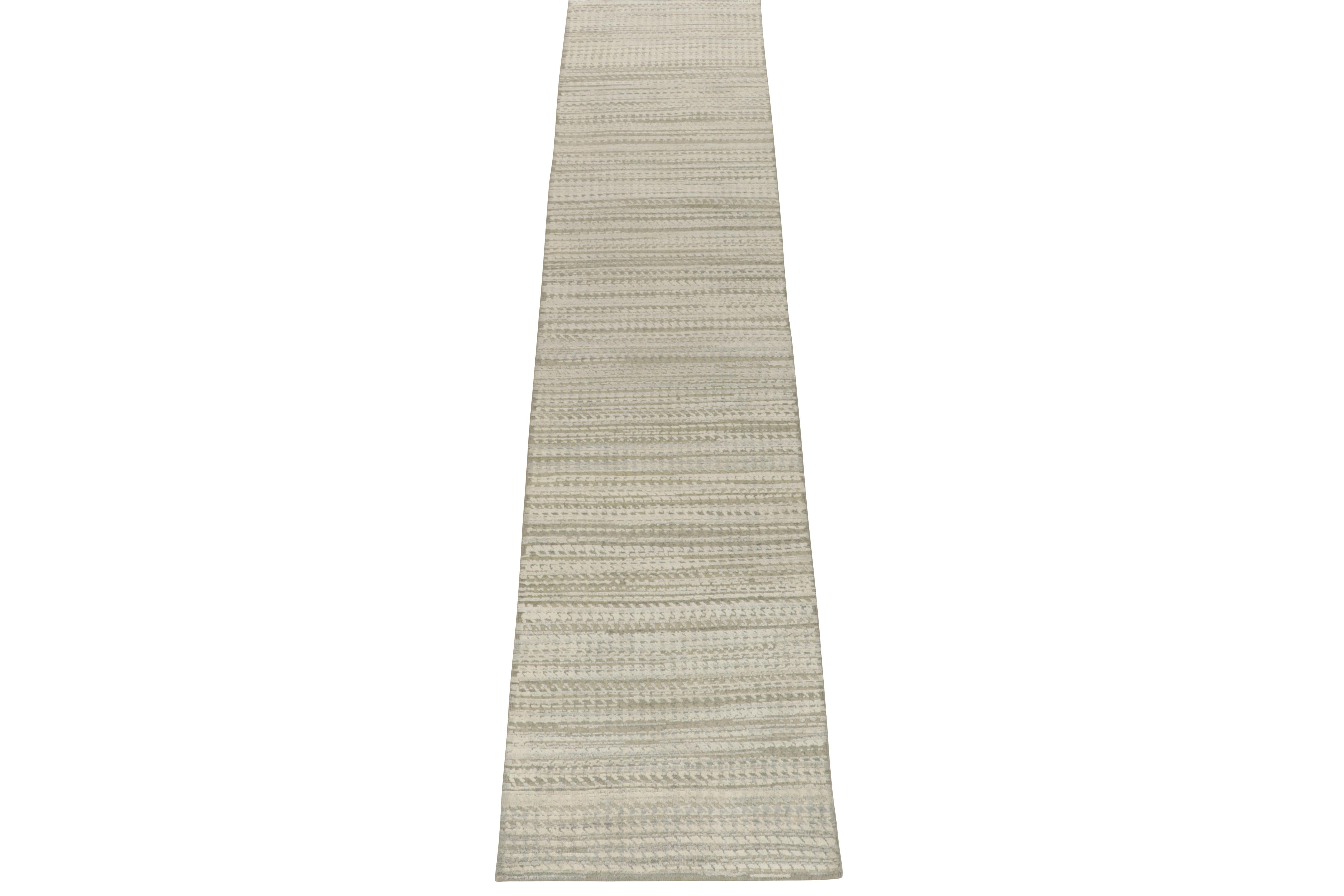 Hand knotted in a fine blend of wool & silk, a scintillating 2x12 runner from Rug & Kilim’s bold modern selections. 

On the Design: The crisp of gray and white plays with the sharp geometric pattern in an alluring high-low texture. A keen eye may