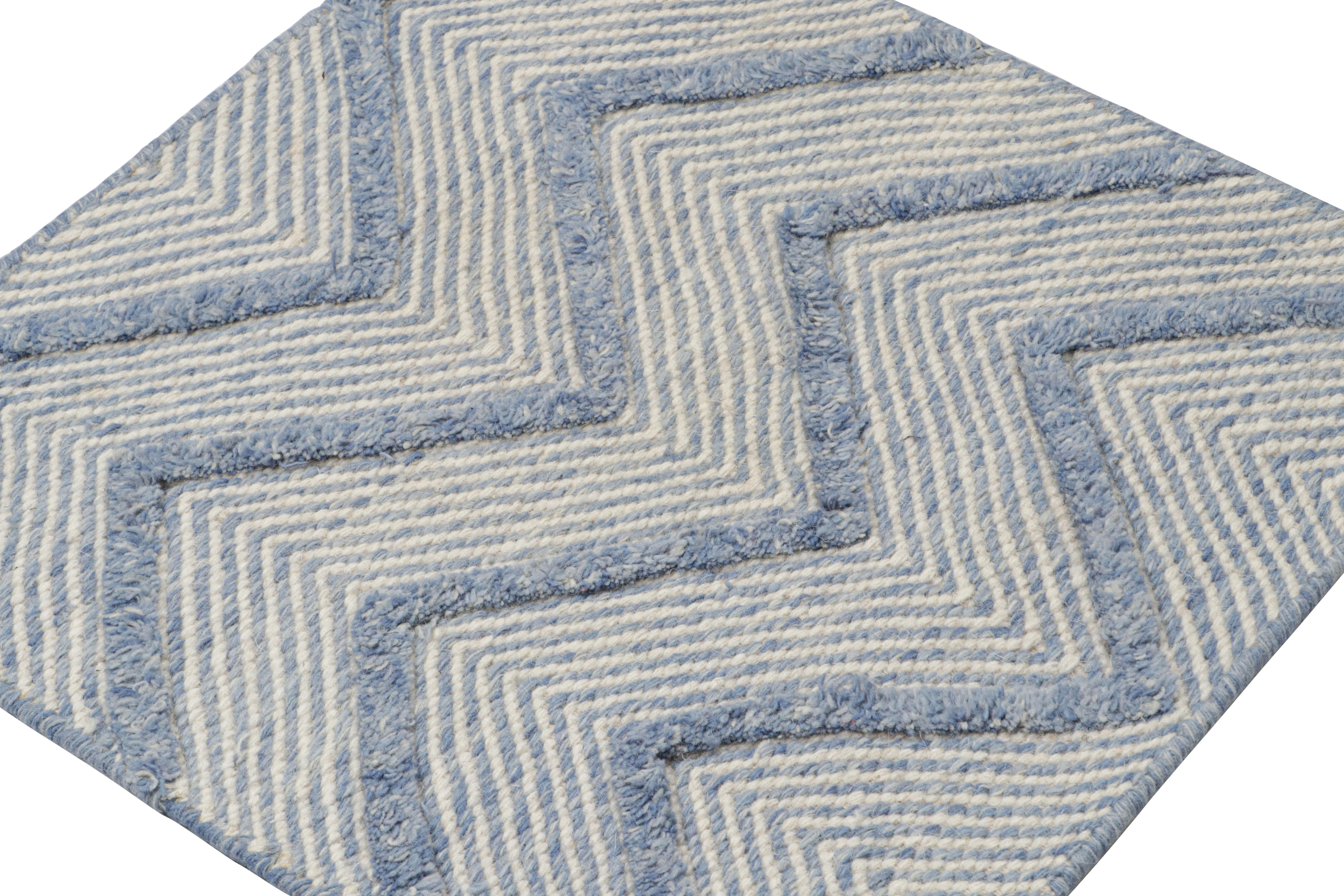 Handwoven in wool, a 2x2 scatter rug from Rug & Kilim’s modern selections.

On the Design

The piece plays flatweave and pile together as seen in the larger chevron patterns which sport a shaggy, high-pile texture that stands out from the flatweave
