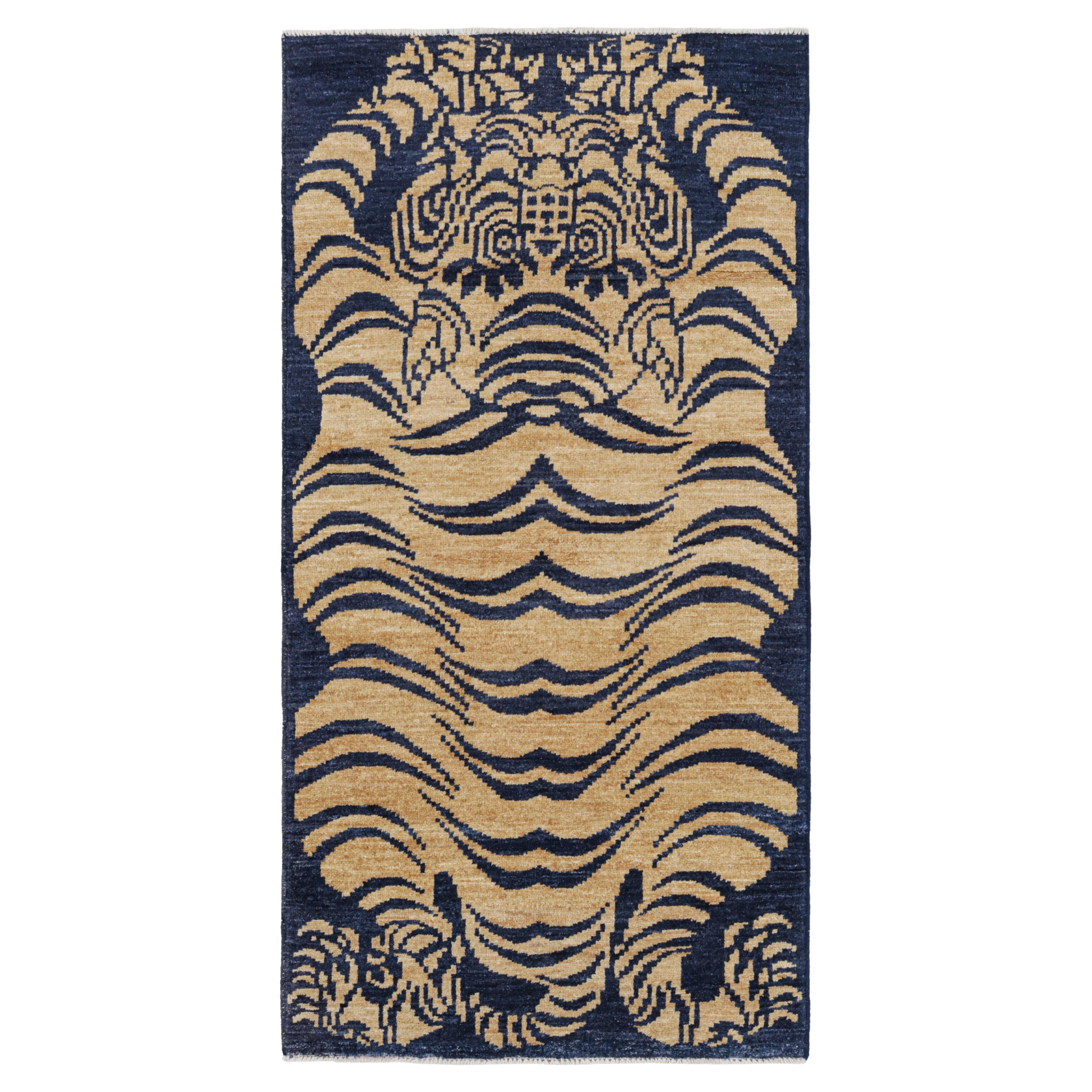 Rug & Kilim’s Contemporary Tiger Skin Rug in Navy Blue with Gold Pictorial