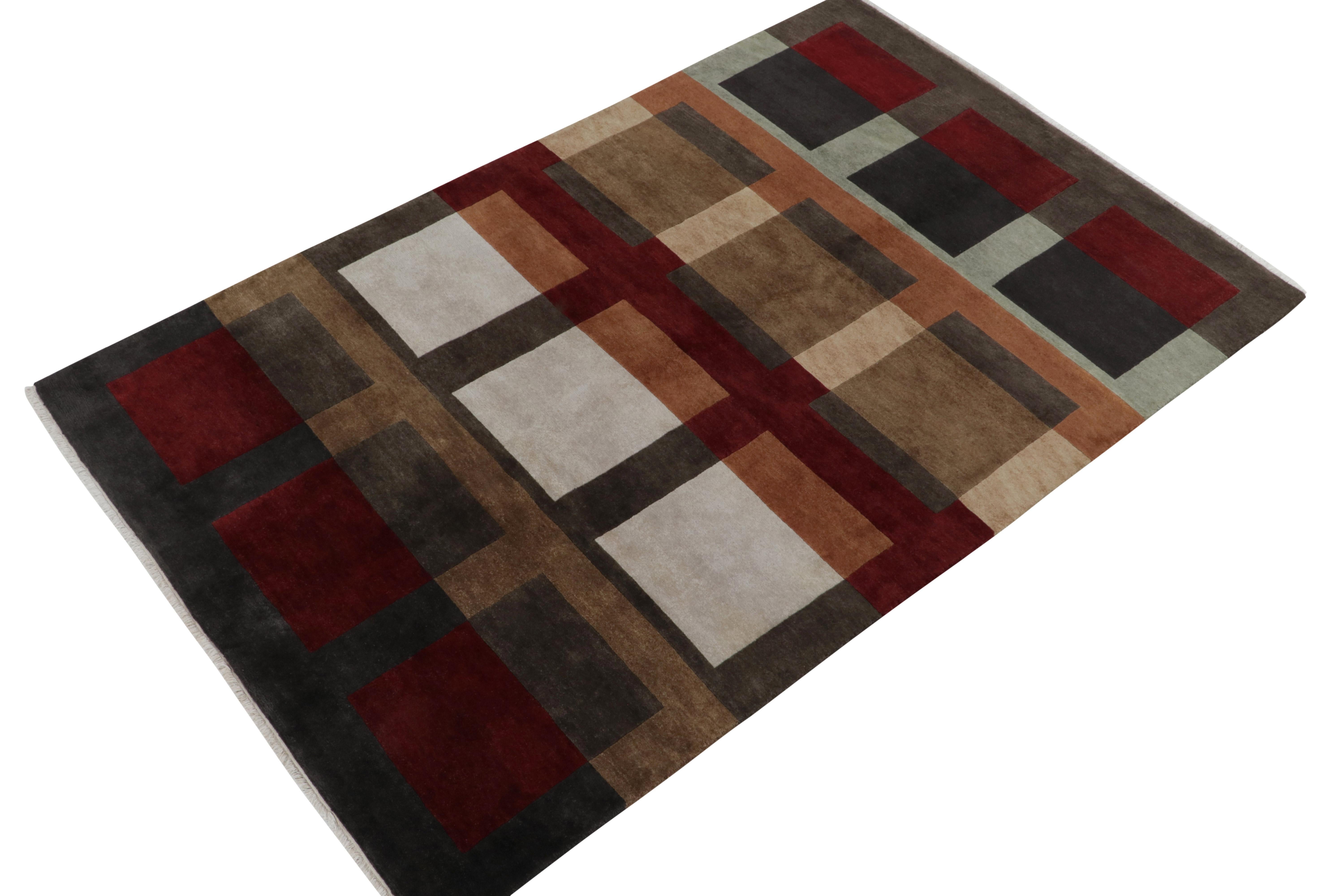 From Rug & Kilim’s bold modern works, a 6x9 hand-knotted wool piece inspired by Cubist Art Deco rugs. This particular carpet showcases a refined geometric pattern in gray and brown with red and blue, beautifully complemented by a natural sheen in