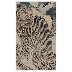 Rug & Kilim's Custom Tiger-Skin Rug with Beige/Brown, Blue, Black Pictorial (tapis en peau de tigre sur mesure avec pictogramme beige/brun, bleu et noir)