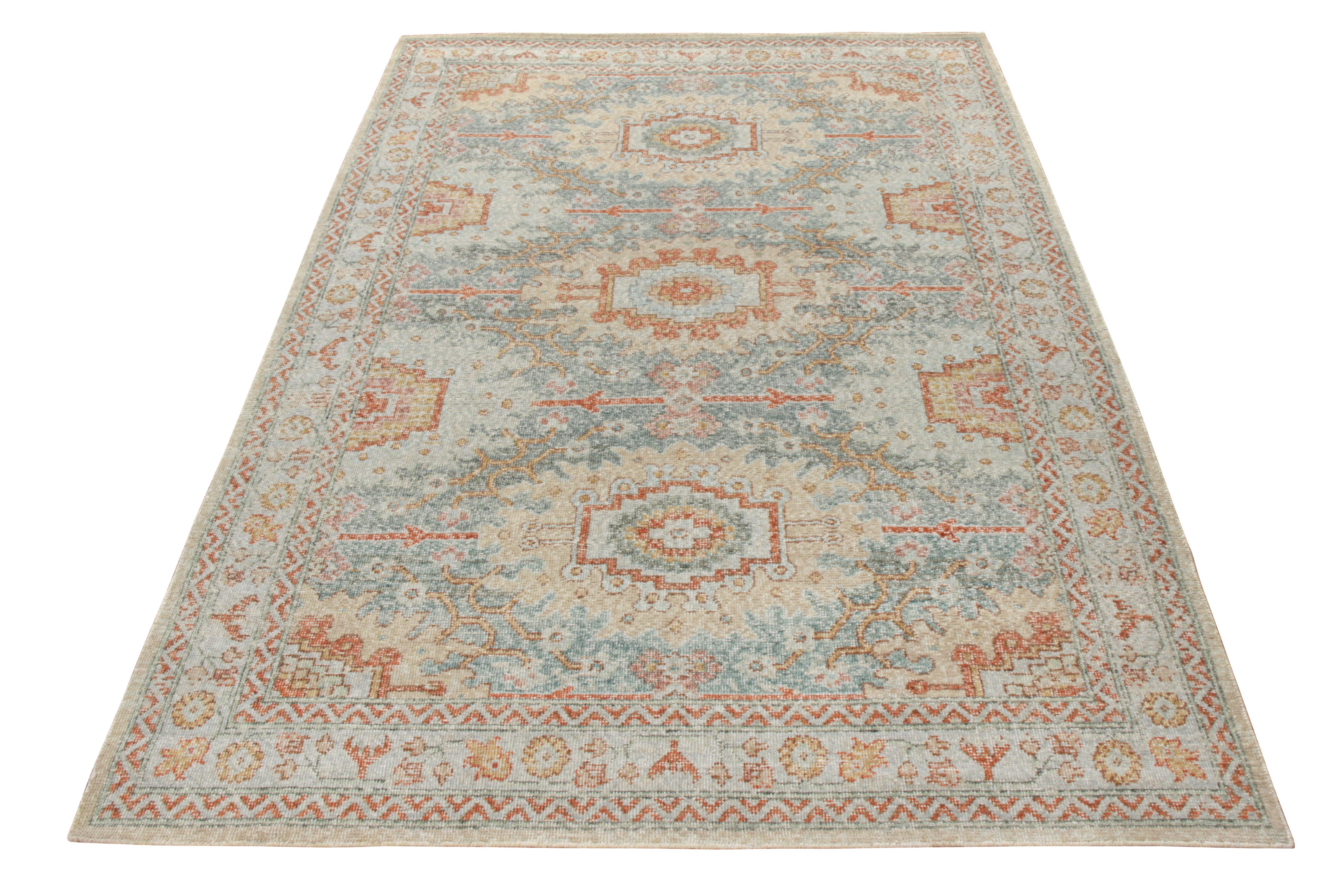 Un esempio di tappeto personalizzato 6x9 in stile distressed disponibile nella collezione Homage di Rug & Kilim. Annodato a mano in lana con sfumature positive-negative di blu e rosso-arancio in contrasto con il beige-marrone, il tappeto presenta un