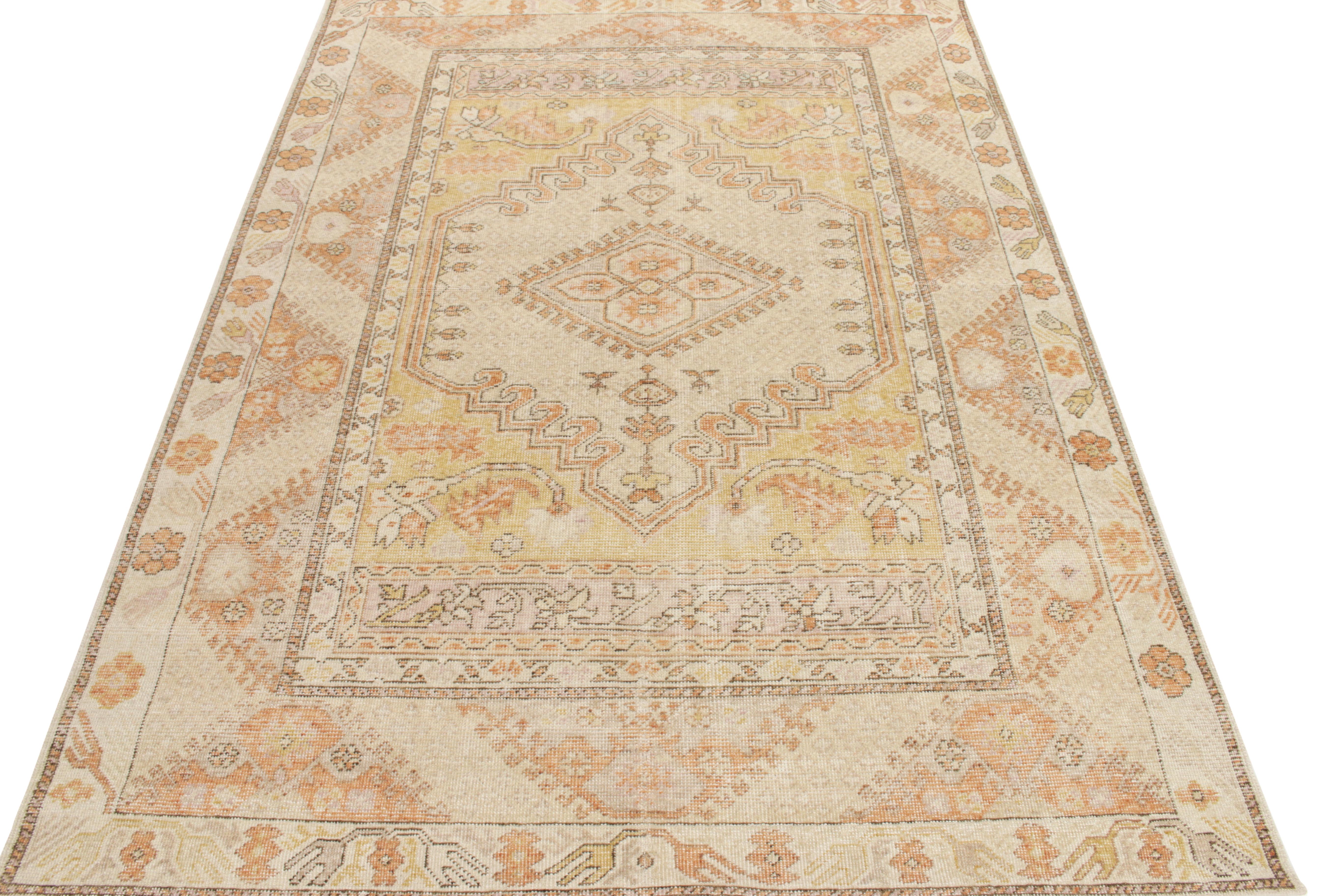 An elegant distressed style rug from Rug & Kilim’s Homage Collection. Hand-knotted in wool, this 6x9 piece features a montage of geometric & floral patterns in nomadic sensibilities accompanying medallions in cream, canary yellow & tangerine