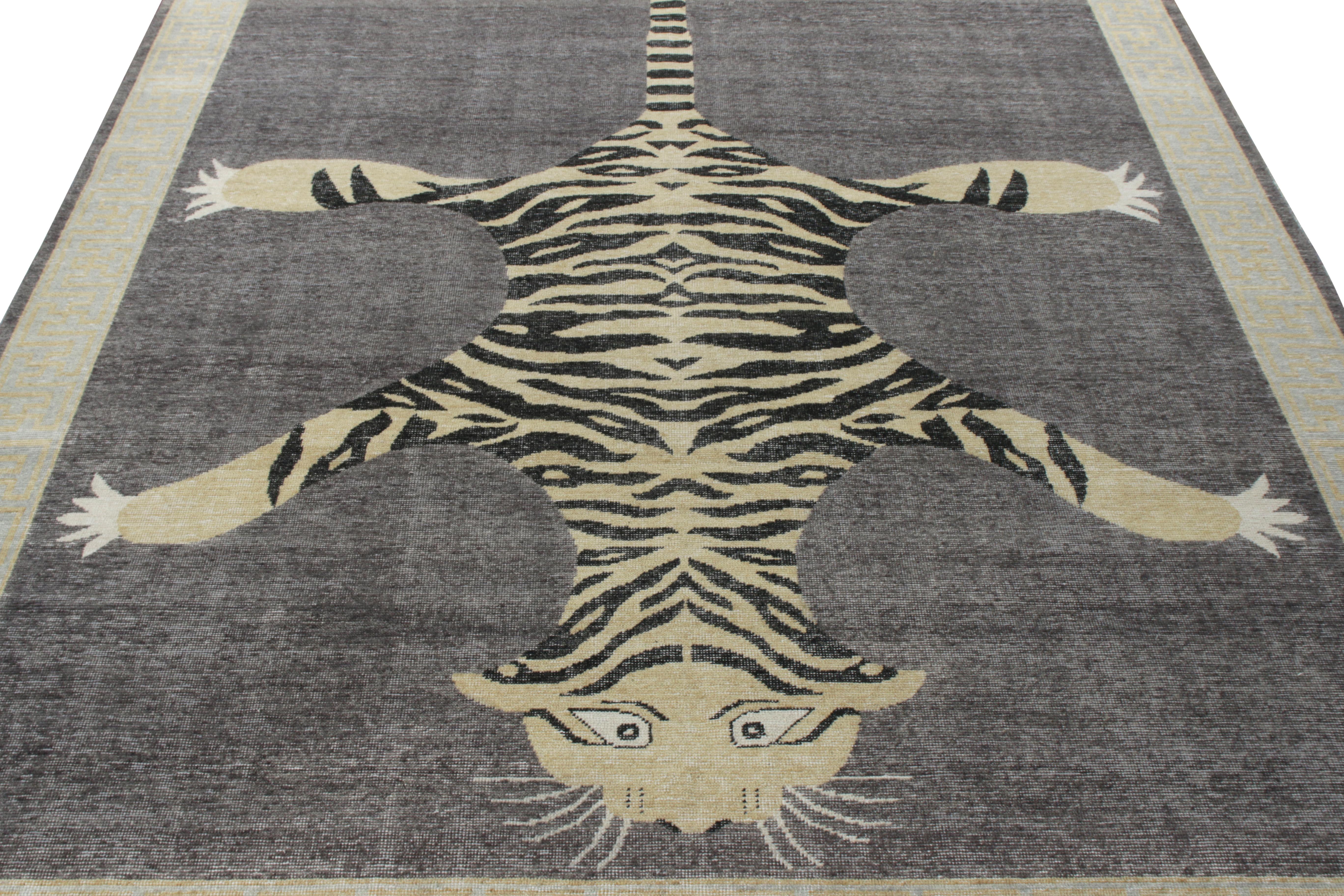 A 9x12 example of a hand-knotted wool custom rug from Rug & Kilim’s Homage Collection. Inspired by antique Indian tiger skin rugs, the piece features a majestic tiger representation in the center on a bold gray background for a sharp dimensionality