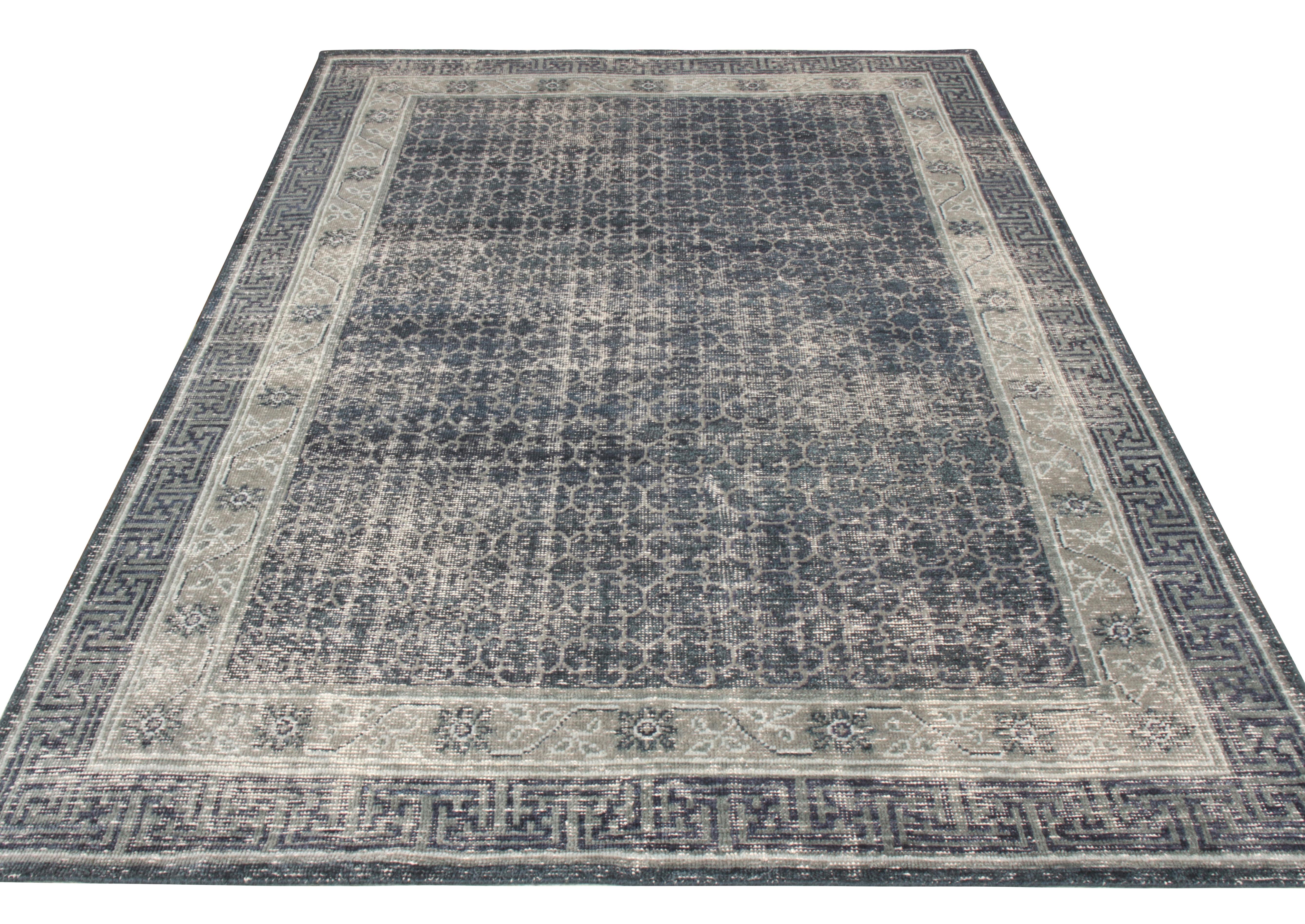 A rich hand knotted wool rug from Rug & Kilim’s Homage collection. Spanning across a 6x9 scale, this distressed style rug witnesses a thoughtful play of mature blue and gray-silver colorway gracefully complimenting the intricate geometric pattern