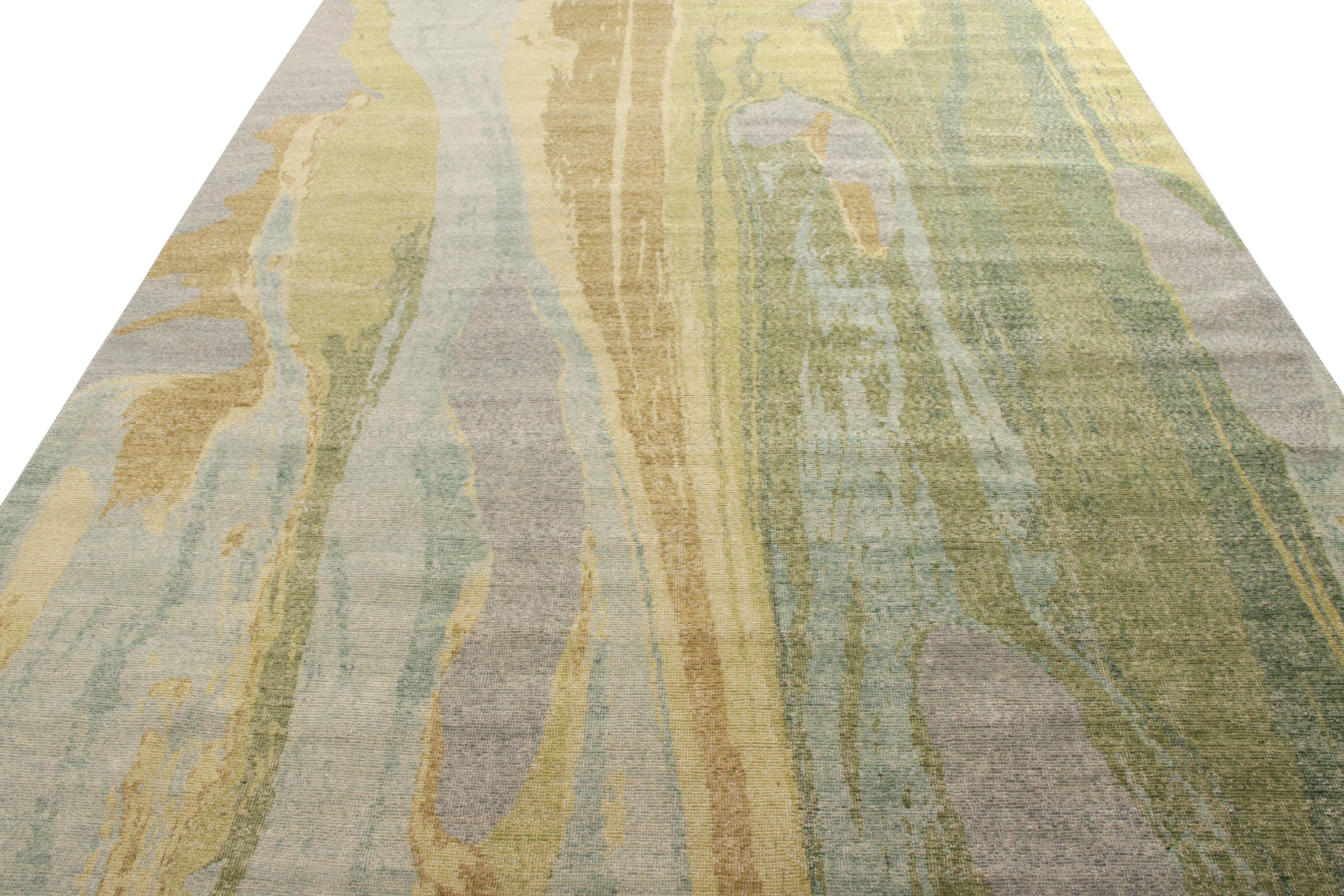 A unique take on abstract design, Rug & Kilim welcomes this 9 x 12 addition to the modern selections in their distressed style Homage Collection. The rug cherishes a smooth pattern in a soothing blue, green, and beige-yellow hues similar to a marble