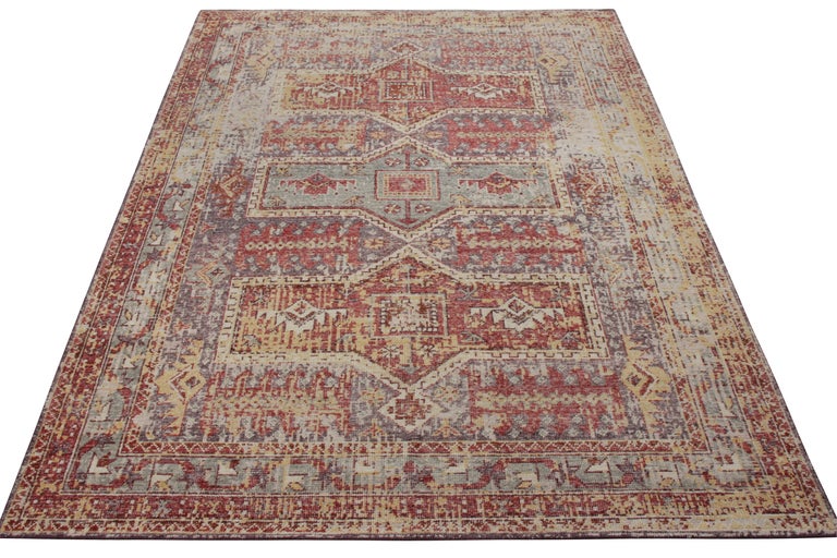 Rug & Kilim presents this classic custom piece from its Homage collection. Hand knotted in wool, this 6x9 example of the shabby chic rug witnesses distress across the scale while beautifully complementing its tribal style pattern in blue, red,
