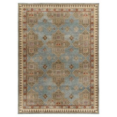 Rug & Kilim è un tappeto moderno in stile degradato con motivi geometrici blu, oro e rosso.