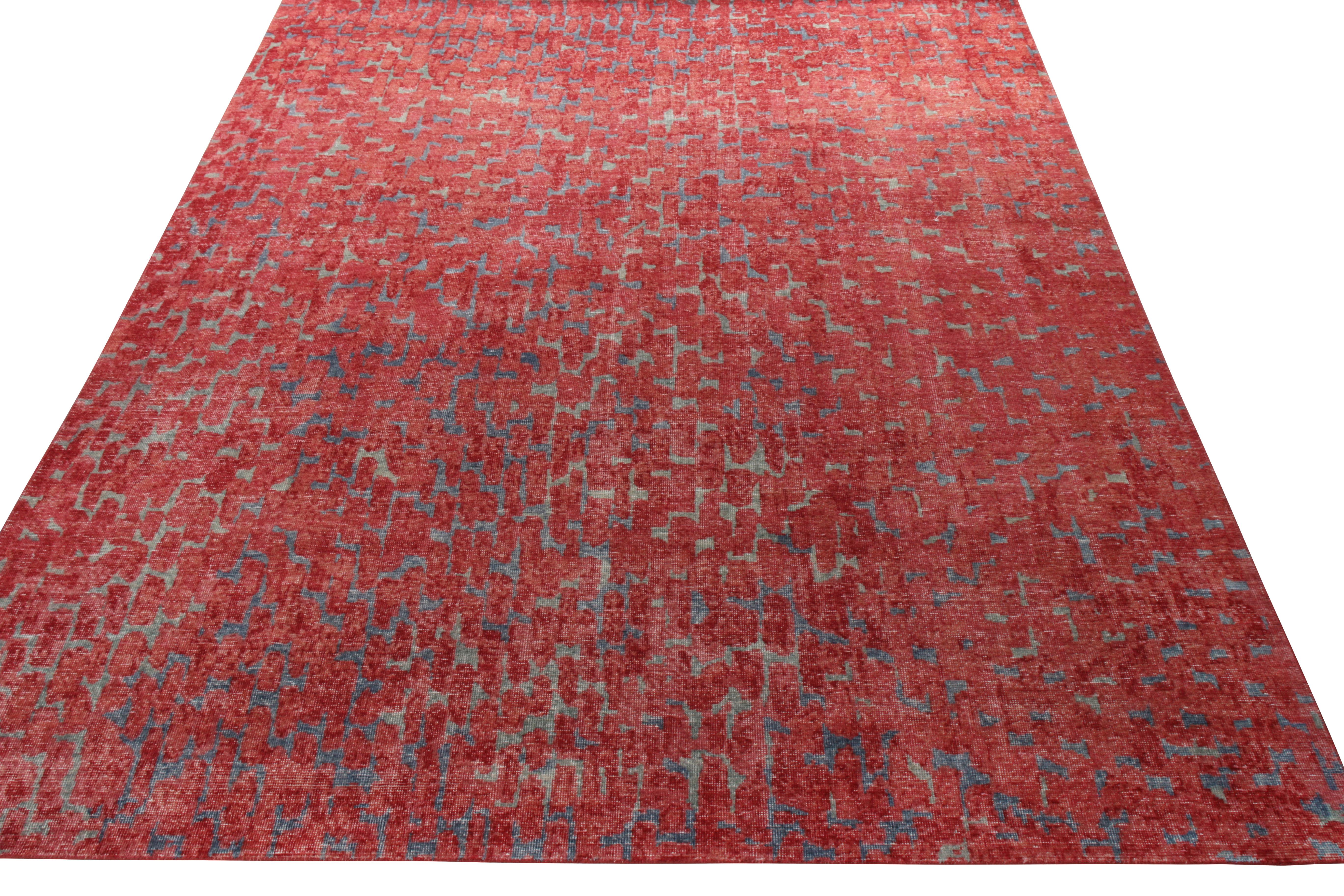 A 9x12 hand-knotted rug from Rug & Kilim’s Homage Collection. Embedded in modern imagination, the rug carries a shabby chic vibe that flourishes on the scale. The geometric pattern fills the frame in vivid shades of red and blue that further