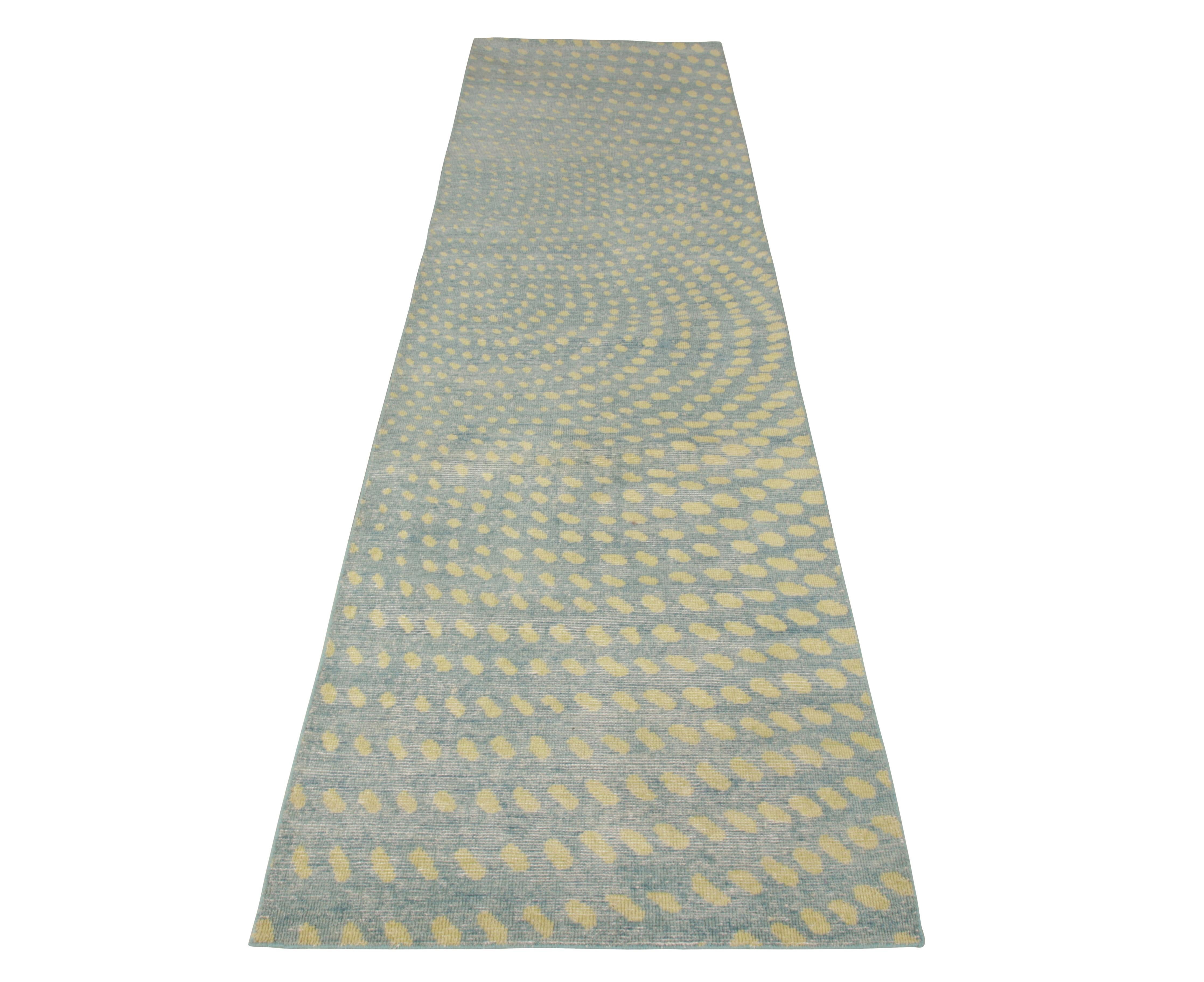 Hand knotted in wool, a welcoming 3 x 12 runner available in Rug & Kilim’s Homage collection. This piece emanates a bright summer vibe with yellow dots playfully dancing on a pervasive blue background scattering across the length of the weave. The