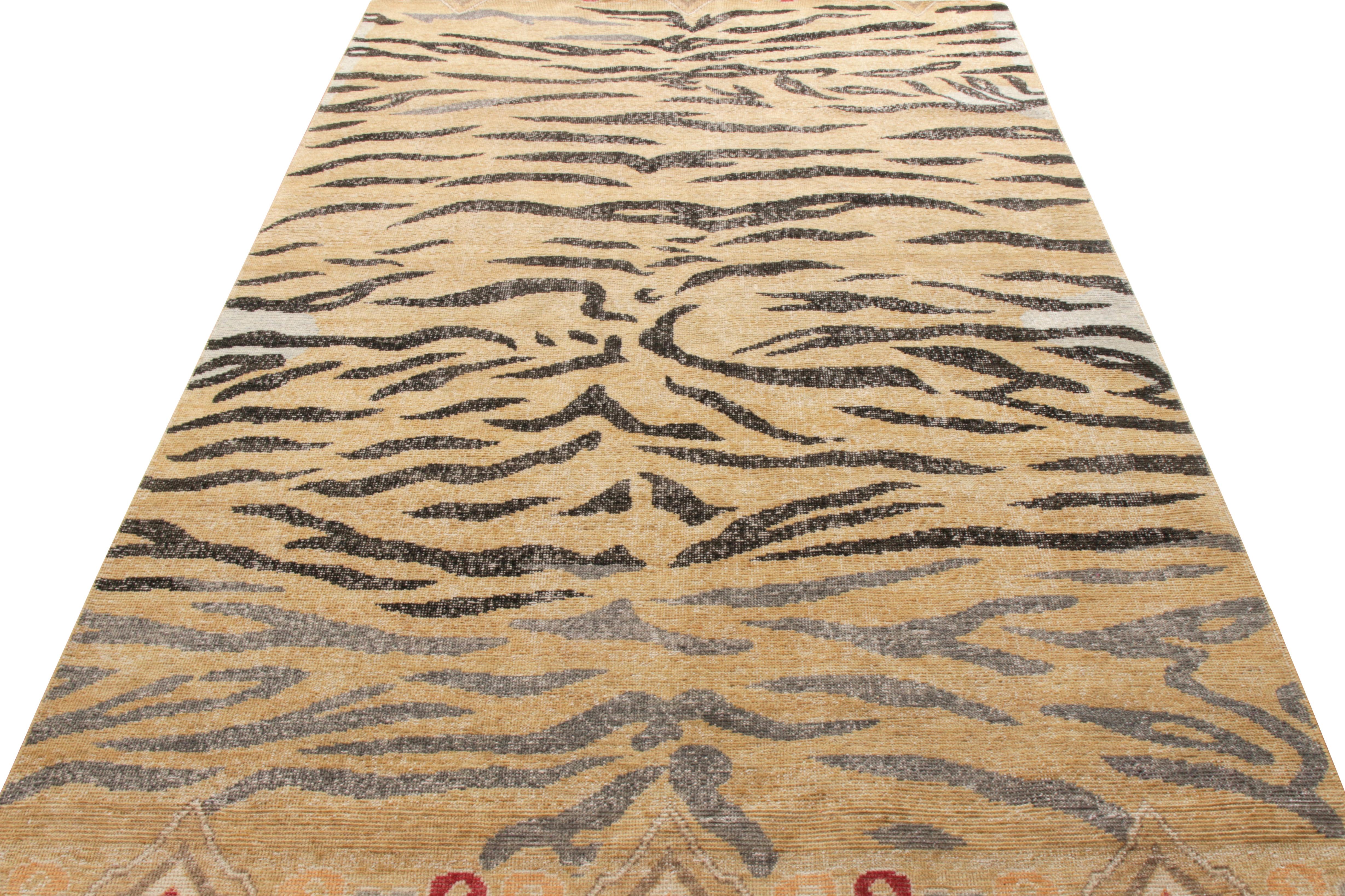 An ode to celebrated classic tiger rugs in the distressed style coming from the Homage Collection by Rug & Kilim. Hand knotted in wool, a 6x9 scale depicting black animal stripes in beige-brown with hints of orange, balanced out by gray-blue for an