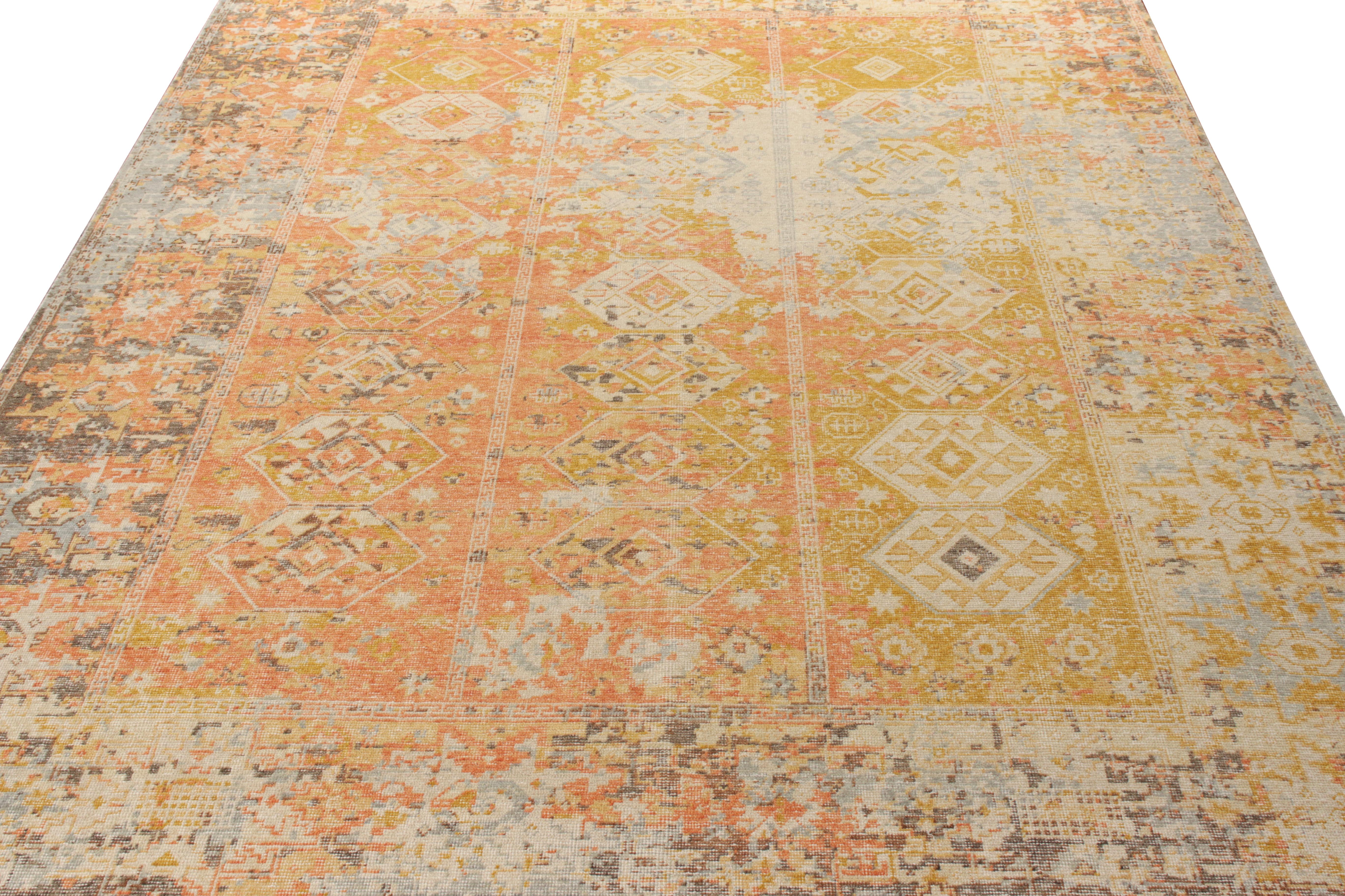 Hand knotted in wool with a unique blend of yarn, Rug & Kilim presents this classic piece from its Homage Collection. Sized at a gracious 9x12, the rug features a geometric pattern in a distinctive color combination of red-orange, gray-blue and