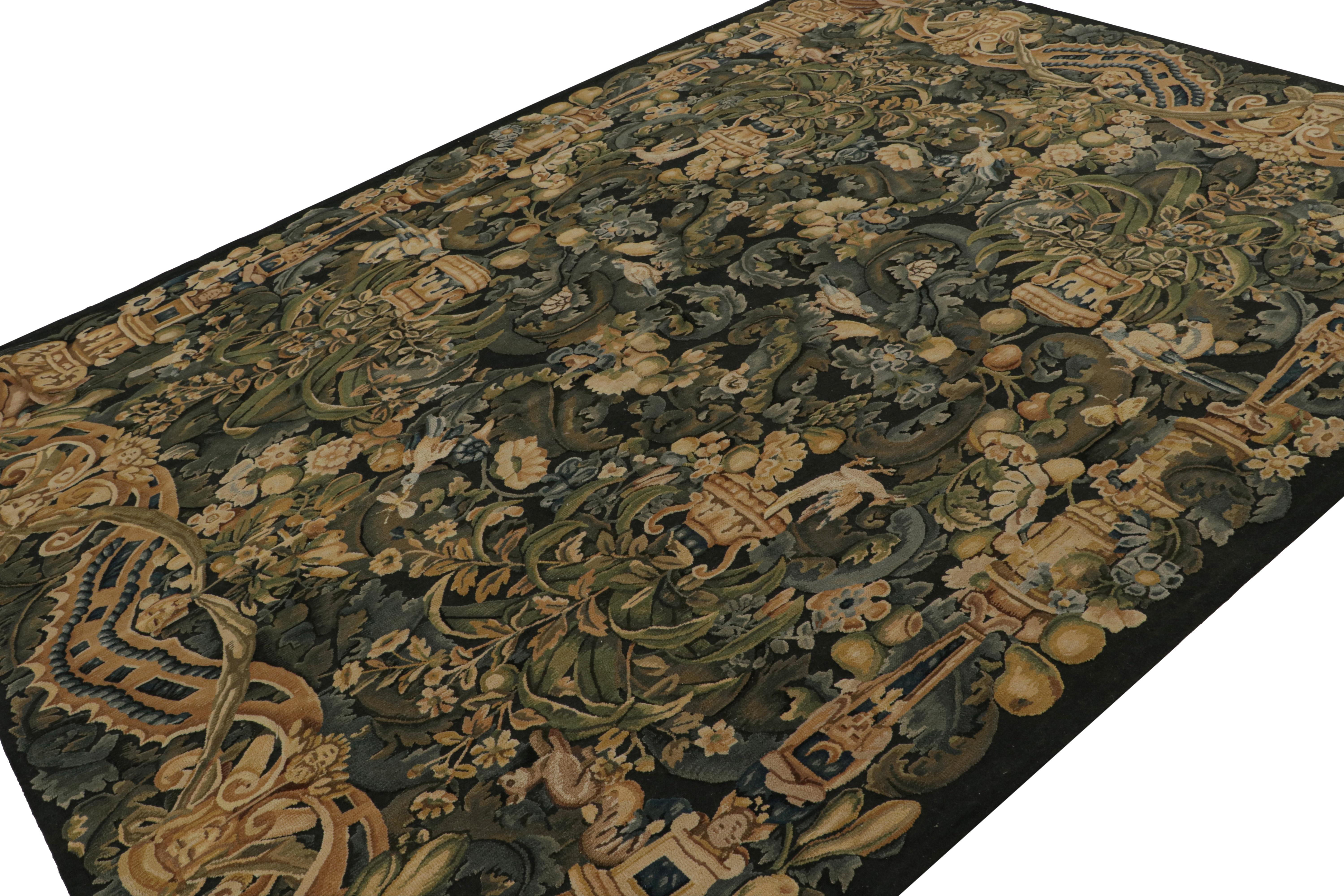 Dieser handgeknüpfte Wollteppich im Format 8x11 wurde von englischen Tudor-Teppichen und -Wandteppichen inspiriert, wobei ein bestimmter Stil unter ihnen als Wappenteppich bezeichnet wurde. Das Design zeigt dichte florale Muster und Bilder in