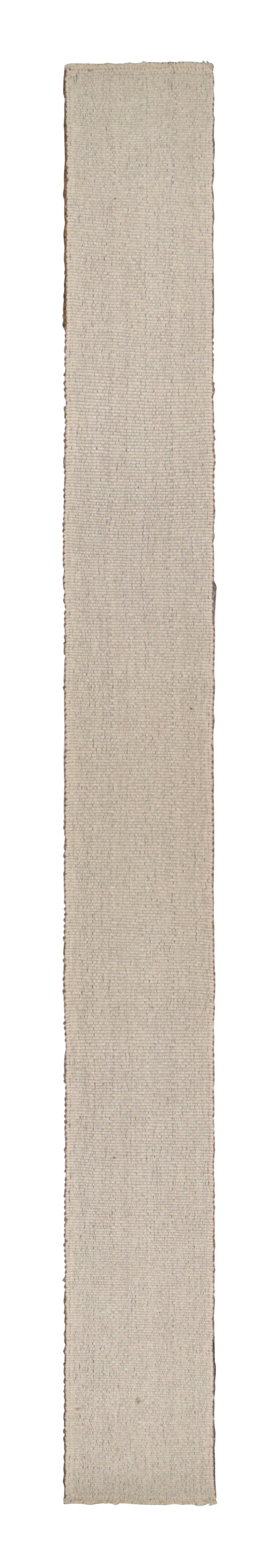 A 2x19 runner Kilim design from our more durable modern flat weave selections, handwoven in wool and originating from India, features beige, chocolate brown accents and an overall cream white undertone in the warp and weft.

On the Design: 

Fondly