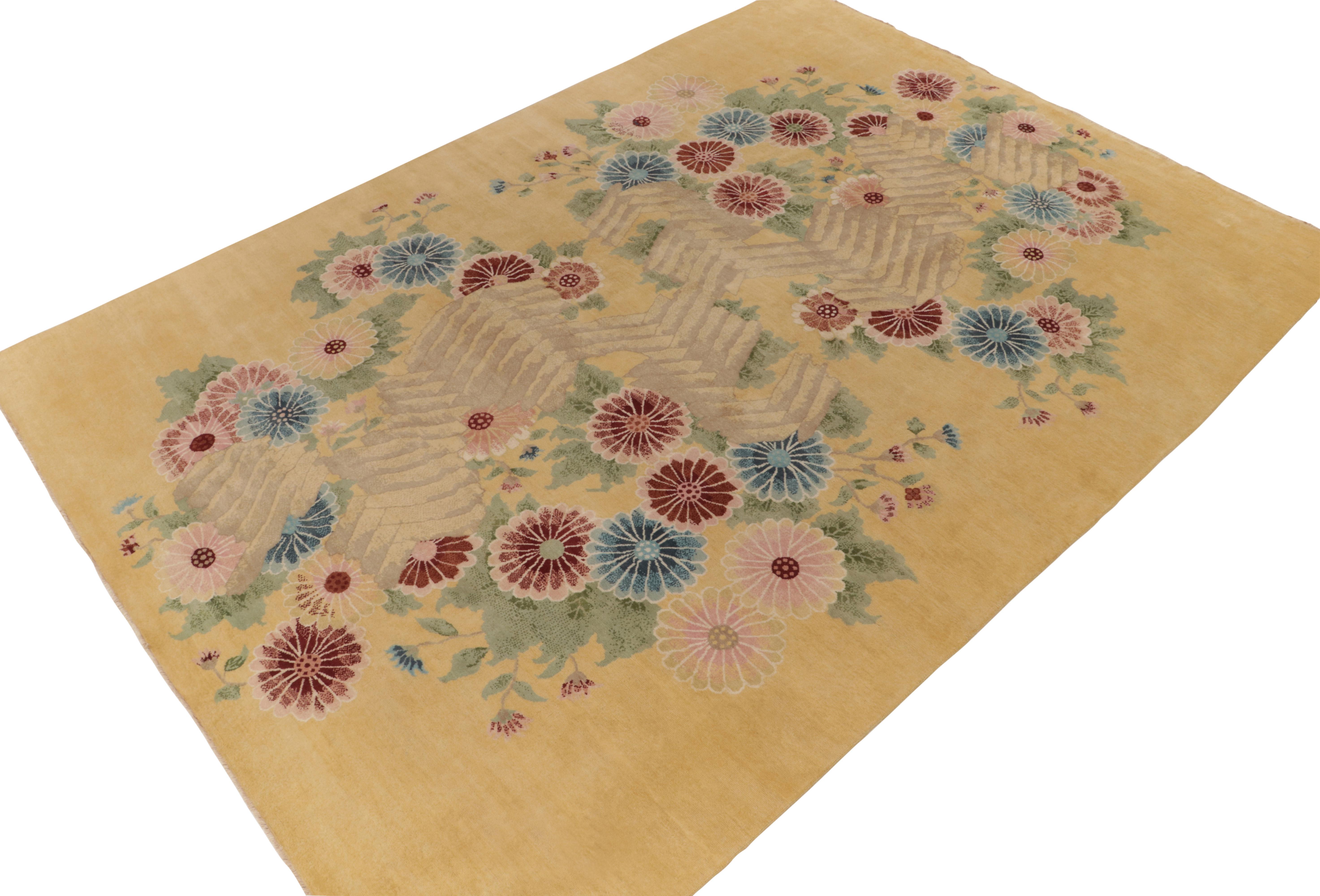 Hand-knotted in wool, a 10x14 ode to French Deco rug styles, from the inspired new Deco Collection by Rug & Kilim. 

On the design: This piece enjoys a most unusual floral pattern in blues red and pink on a regal gold and green backdrop. Keen eyes