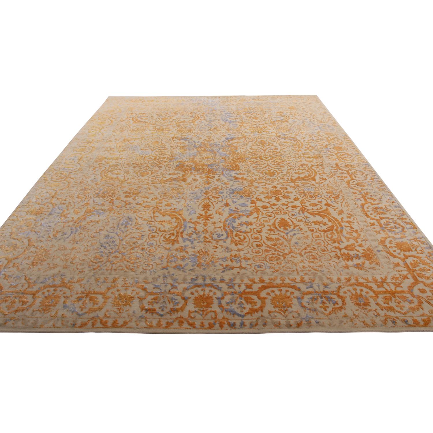 Hand knotted with a unique combination of wool, natural silk and exotic yarn, Rug & Kilim’s latest addition to our custom rug collection enjoys a regal, inviting play of gold and silver-blue colorways in this classically inspired design. Accented by