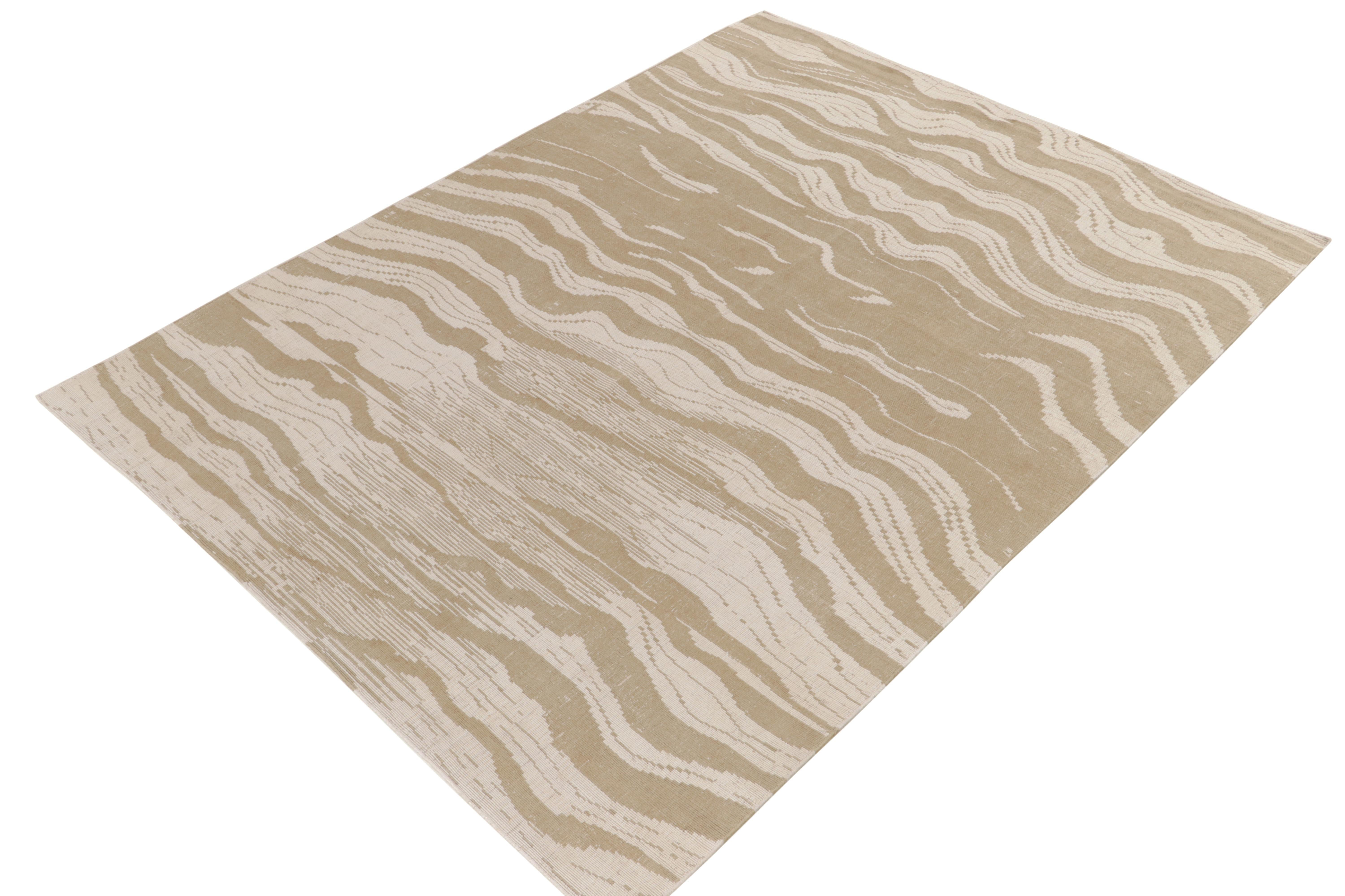From Rug & Kilim’s contemporary collection, a bold take on abstract area rugs in hand-knotted wool and forgiving colorway. Soothing neutral beige-brown and white hues play in a wavy series of stripes—complemented by a subtle textural element seldom