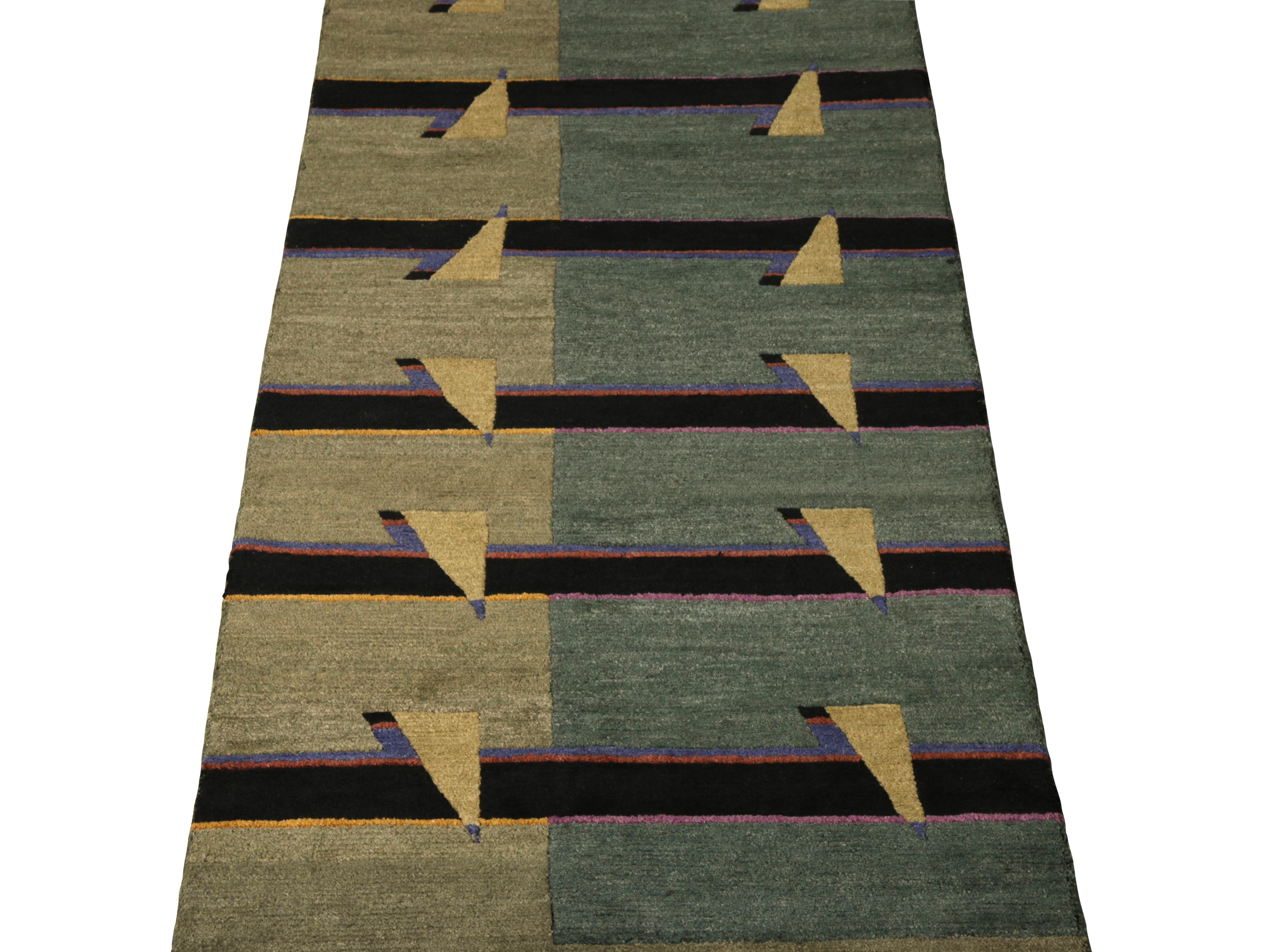 Hand-knotted in wool originating from Rug & Kilim’s New & Modern rug collection, a 3x12 modern runner drawing on cubist design principles in a chic, inviting striped pattern with hues of green, black, and blue lending to the artisan look. 

On the