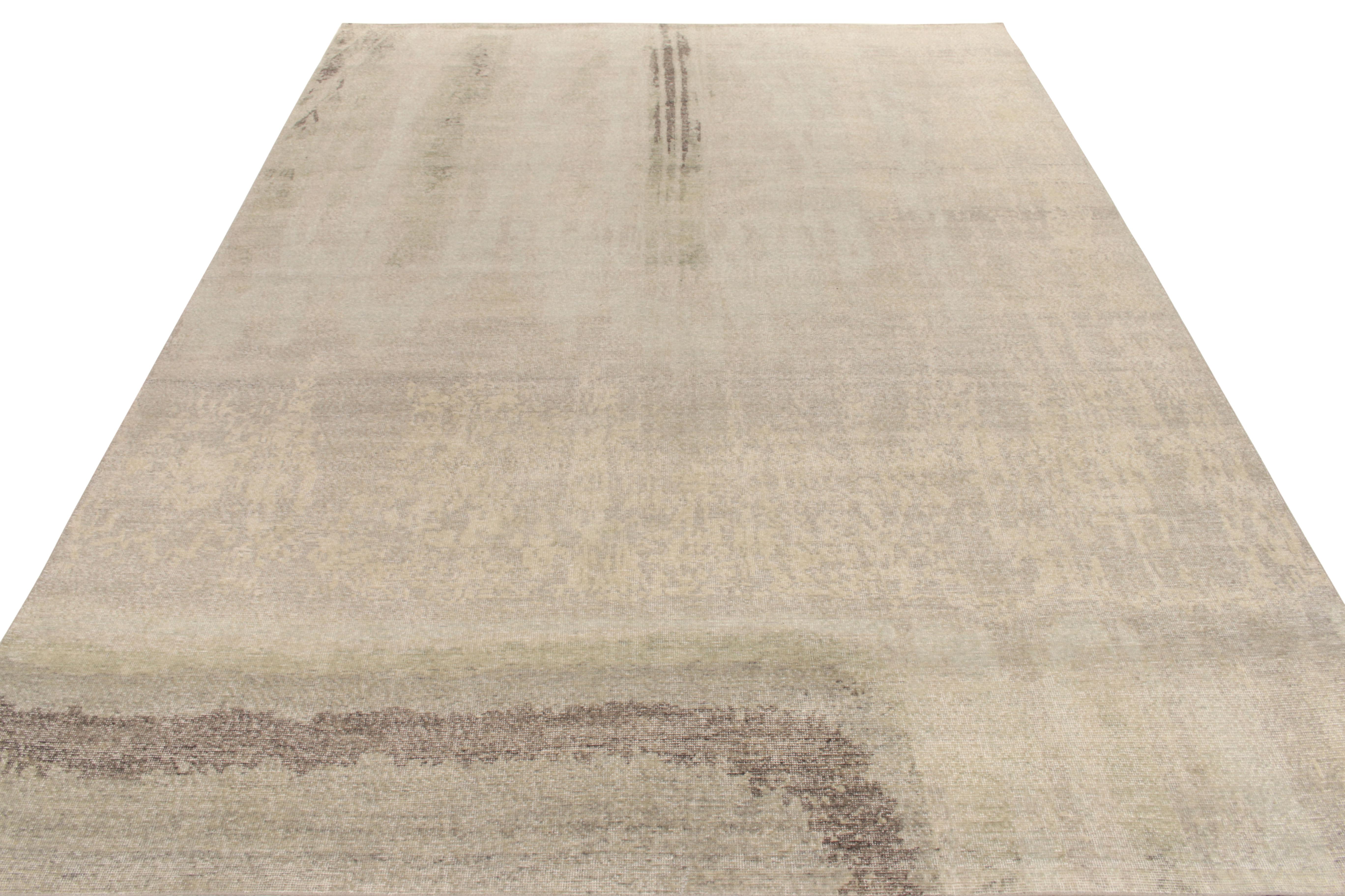 A 10 x 14 hand-knotted wool rug from the Homage Collection by Rug & Kilim. Enjoying handsome hues of beige-brown, blue and gray in a painterly abstract rug pattern, beautifully married with this collection’s textural take on distressed style.