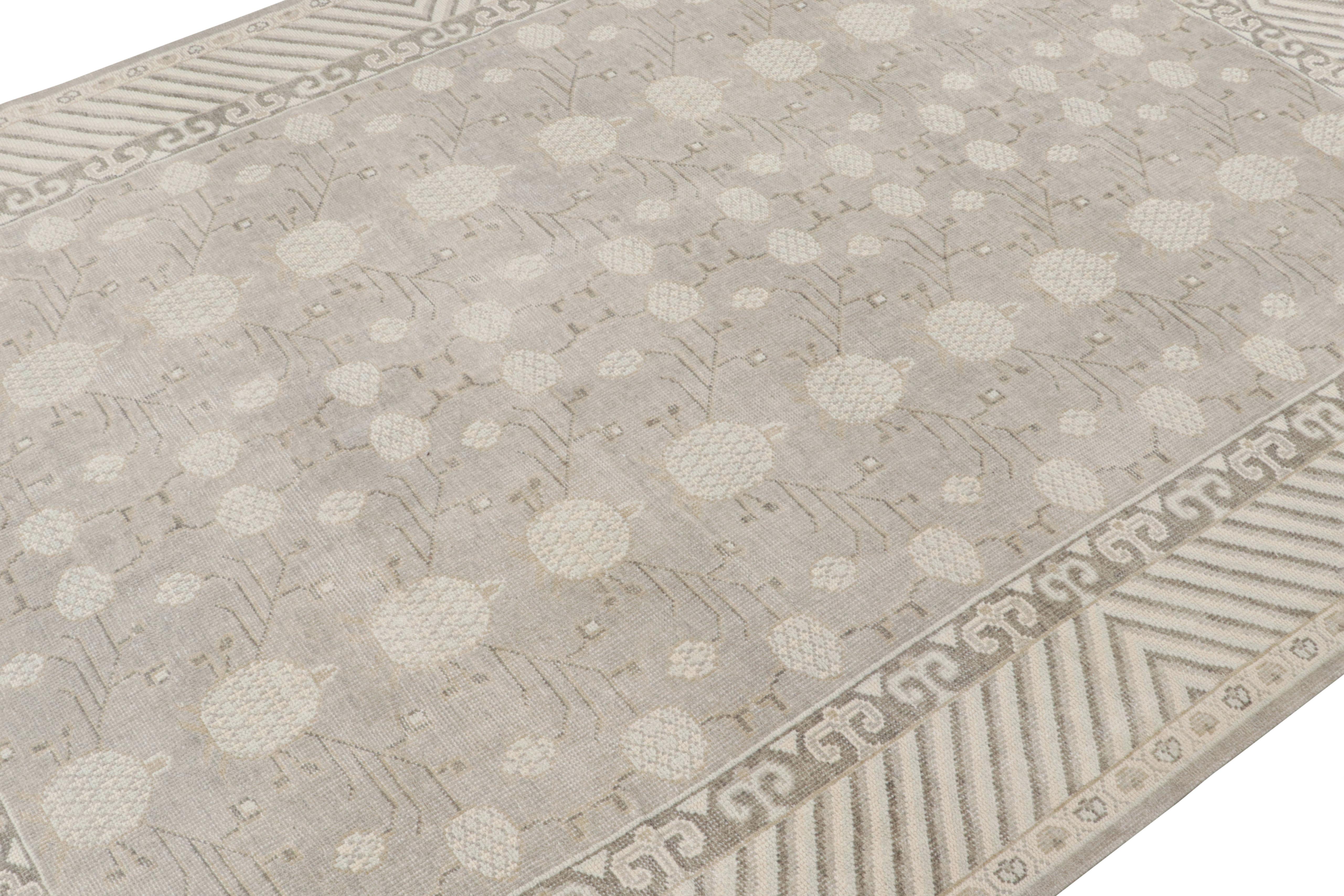 Hand-knotted in wool joining the Modern Classics Collection by Rug & Kilim, this Khotan rug reimagines the time-honored pomegranate and cloud and patterns in a more contemporary, transitional pallet of gray, beige and blue—seldom seen among the