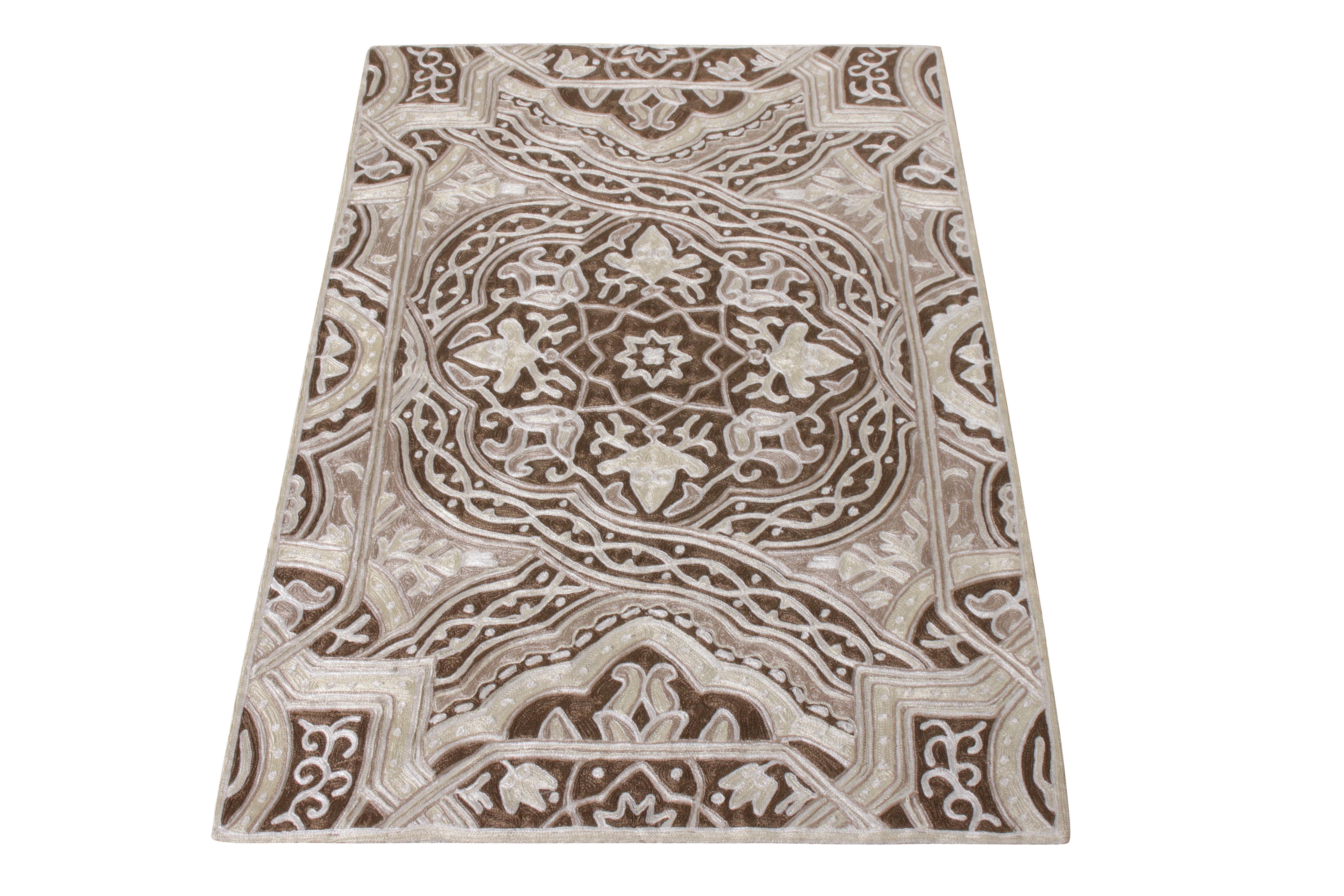 A luscious 3x4 rug in sophisticated hues of beige-brown and white joining Rug & Kilim’s Modern collection. Finely woven in with a meticulous chain stitch marrying a rich colourway and floral pattern, the rug relishes a splendid play of movement and