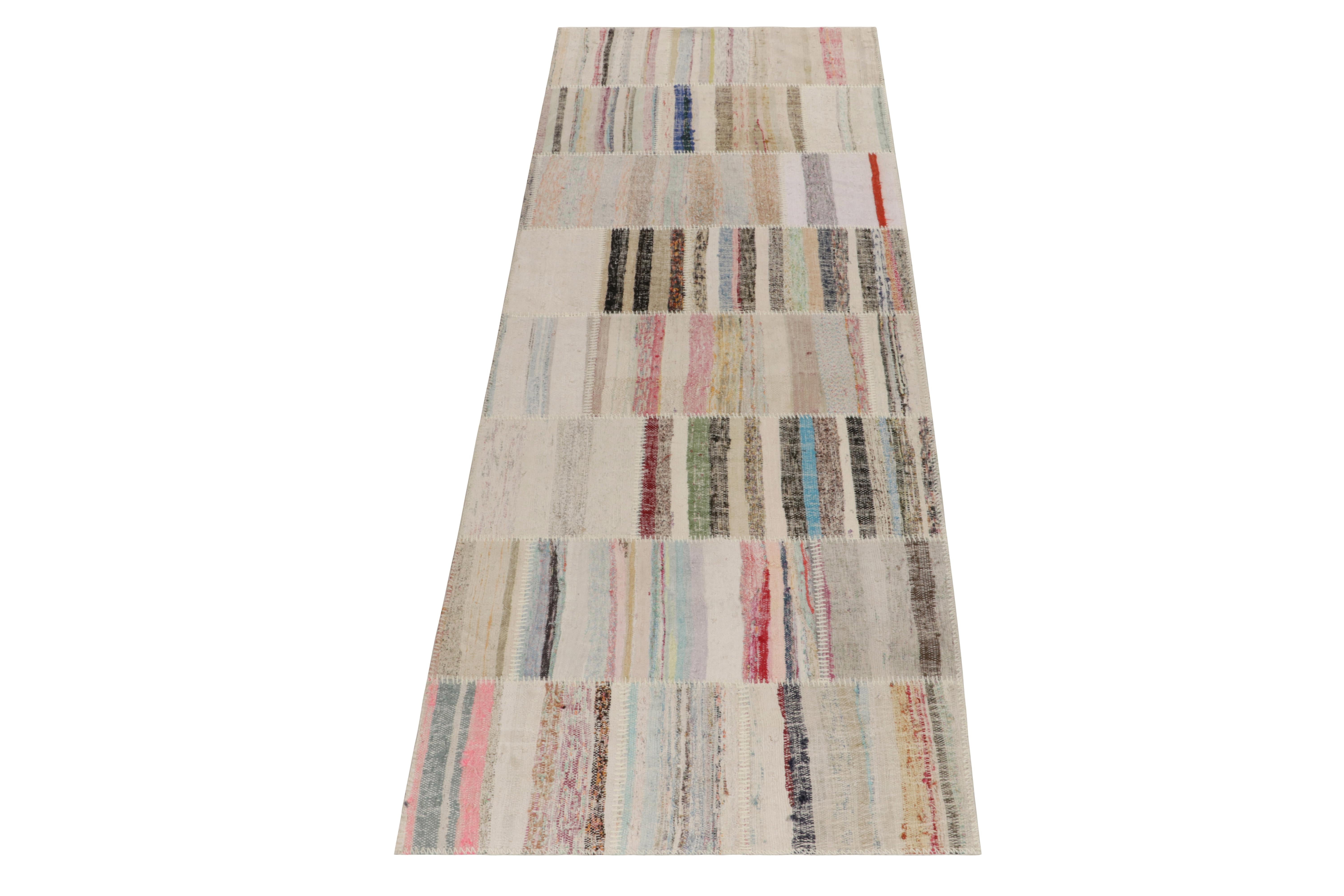 Rug & Kilim takes pride in presenting its artistic vision of patchwork kilim that reimagines vintage yarns into unique pieces of art. This 3x10 flatweave features a striated pattern that lends a smooth sense of movement in variegated shades across