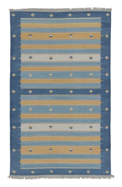Rug & Kilim’s Indian Dhurrie Rug in Blue, Gold and Ivory Geometric Stripes