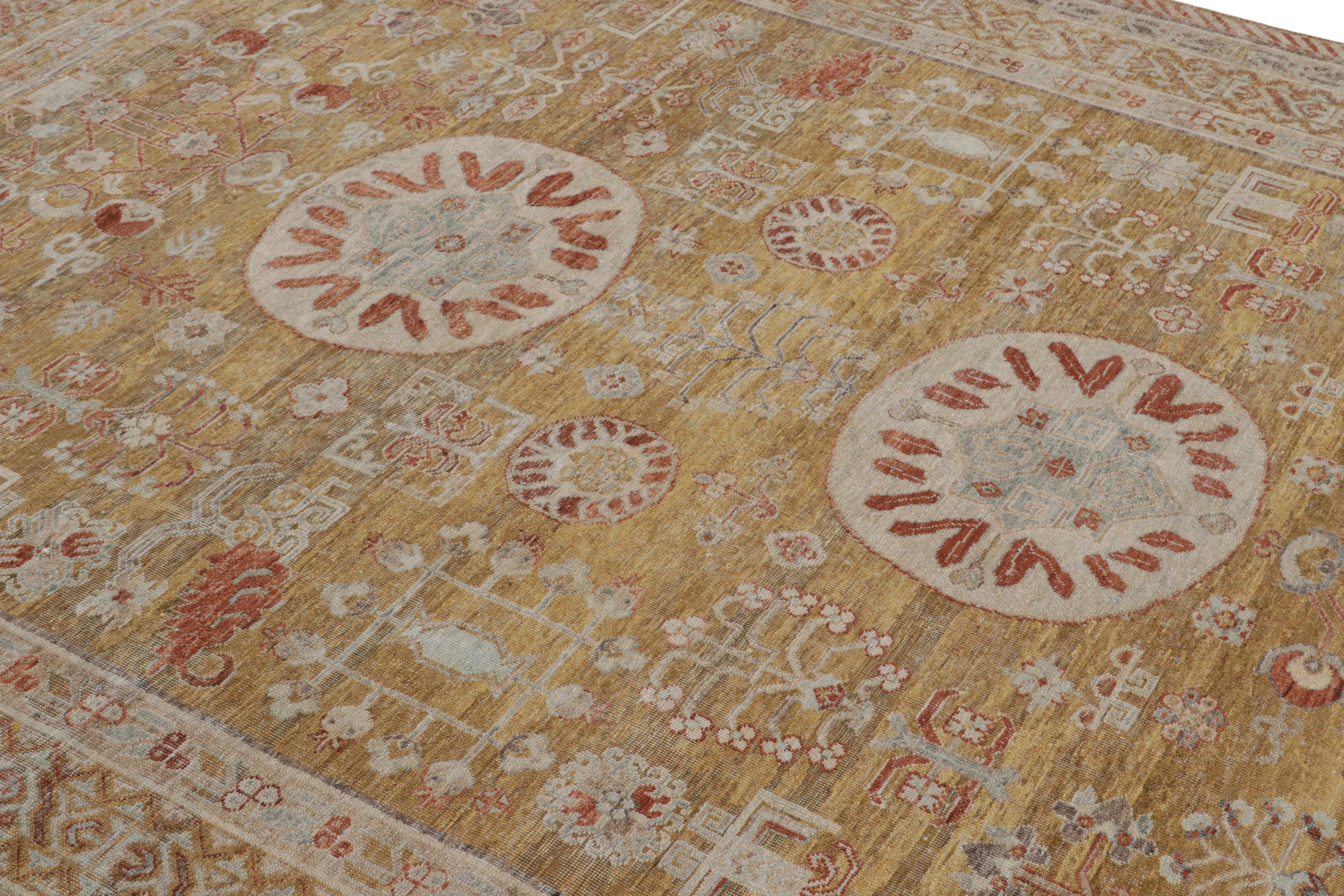 Hand-knotted in wool, this new 8x10 rug from the Modern Classics Collection by Rug & Kilim is inspired by antique Khotan rugs.

On the Design:

The rug carries a gold field and rust red border, underscoring a play of medallion and all over style