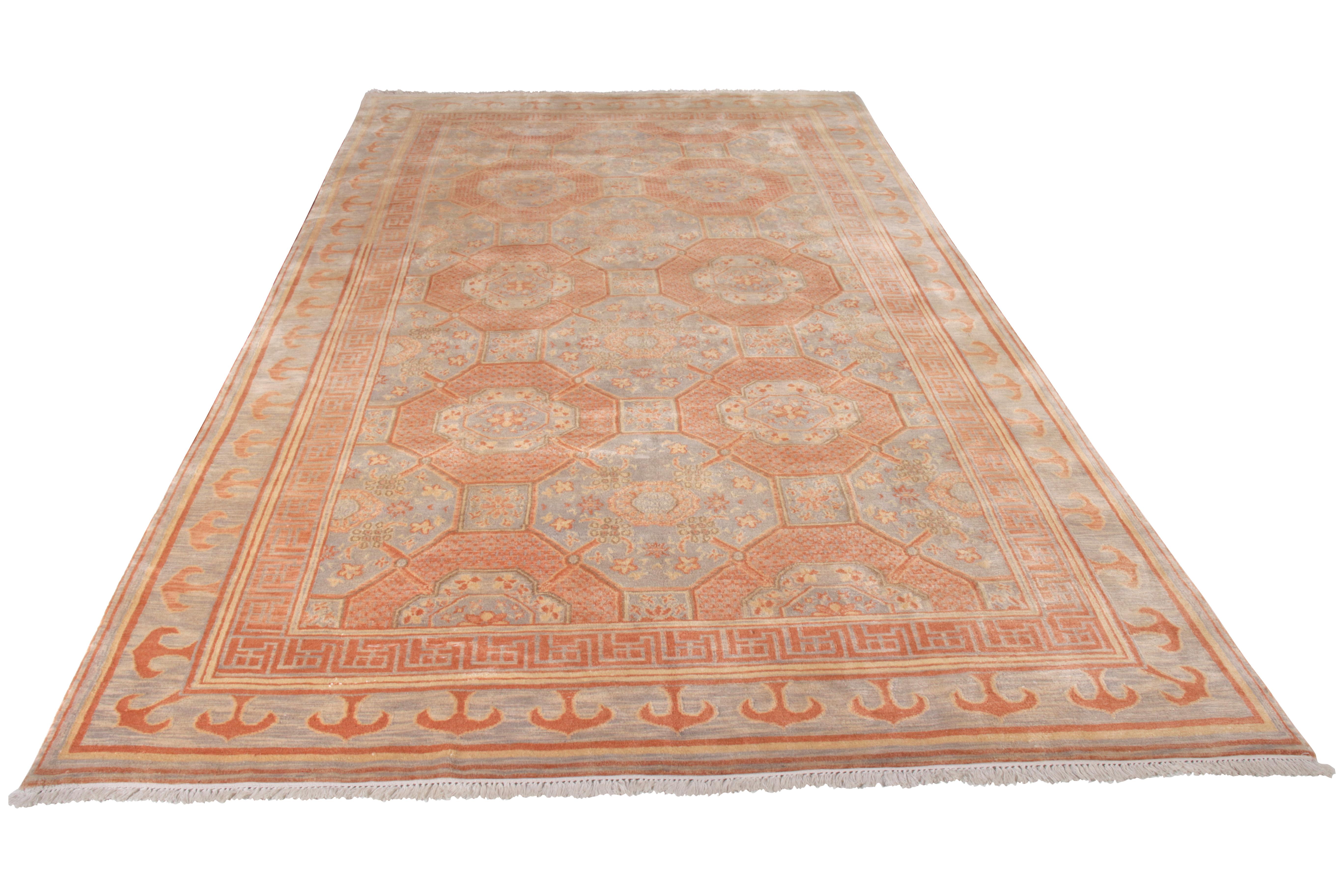An 8x12 ode to venerated Khotan rug styles in blue and orange, joining the Modern Classics Collection by Rug & Kilim. Hand-knotted in wool, marrying graceful geometric medallion and floral elements for a unique nod to this celebrated transitional