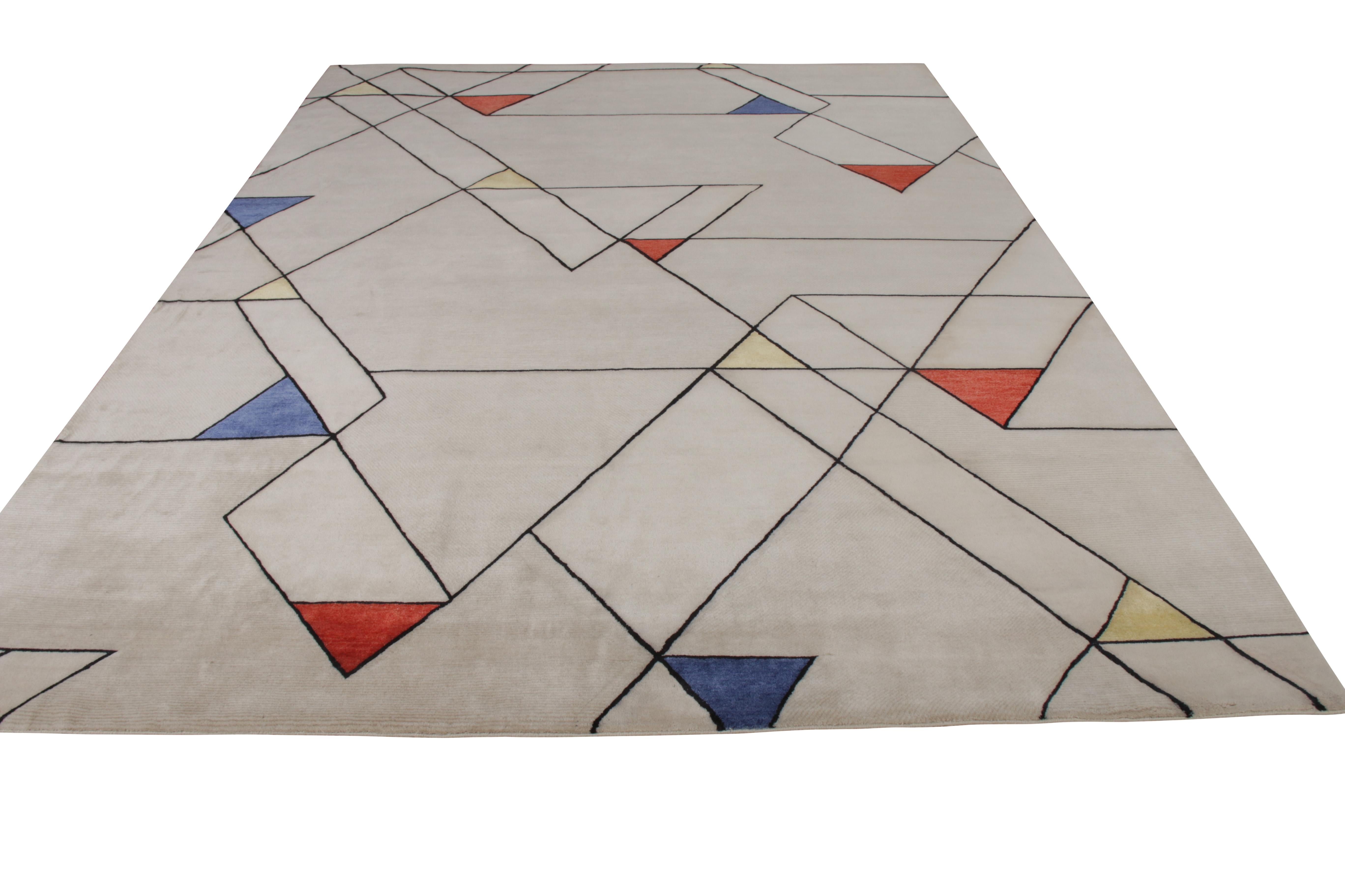 A 9 x 12 rug from Rug & Kilim’s Mid-Century Modern Collection, hand knotted in wool in prevailing silver-gray colors. Joyful multicolor hues accent the geometry with a smart sense of movement and play with the metallic undertone. Exemplifying the