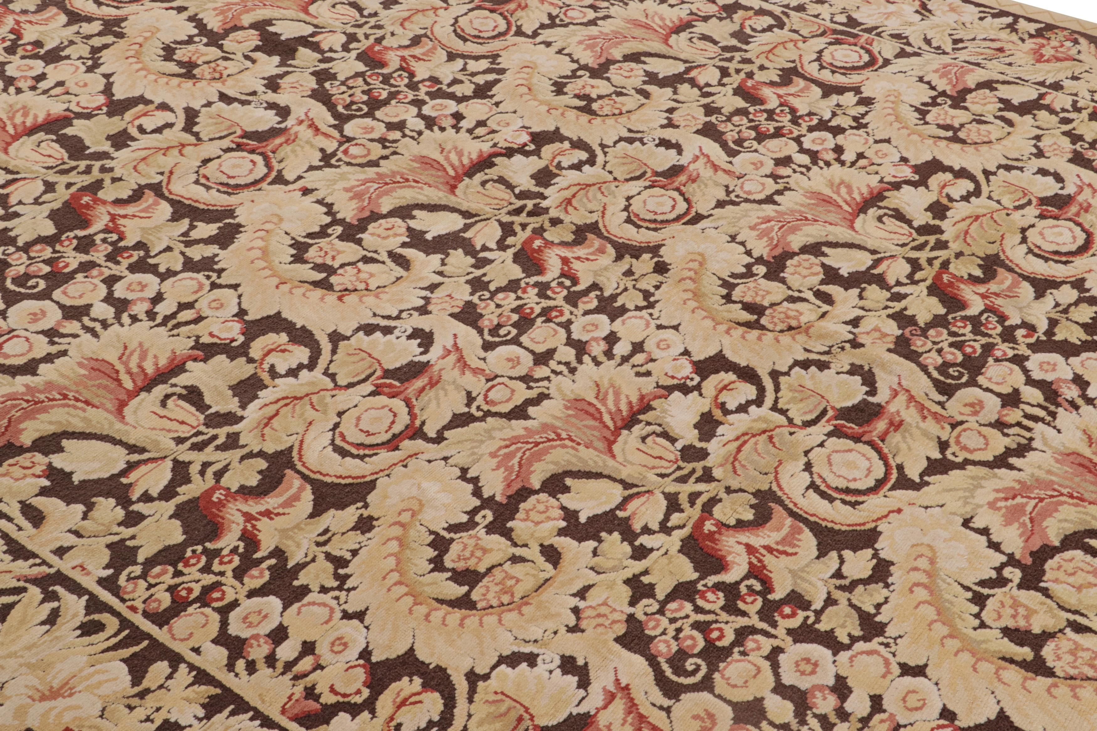 Originating from China, this transitional wool rug enjoys a modern interpretation of an 18th century design. Hand knotted in high-quality wool, the all-over field design distinctly resembles the neoclassical golden-beige, brown, and pink colorways