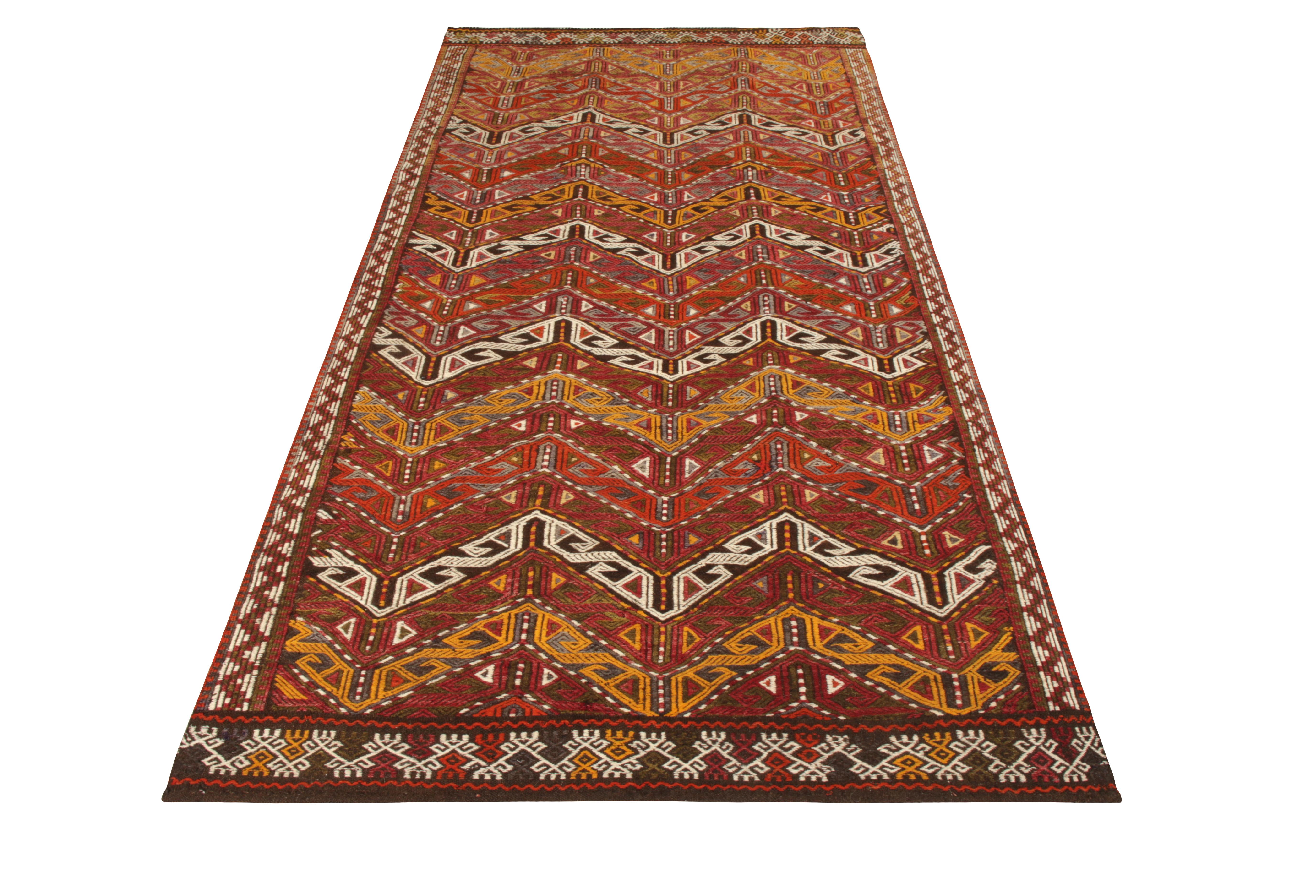 Handwoven in wool, a 5x9 Kilim rug available in Rug & Kilim’s prized collection. A delicious take on geometric design, the rug enjoys an illusion created by repetition of a well defined chevron pattern supporting a variety of other patterns on both