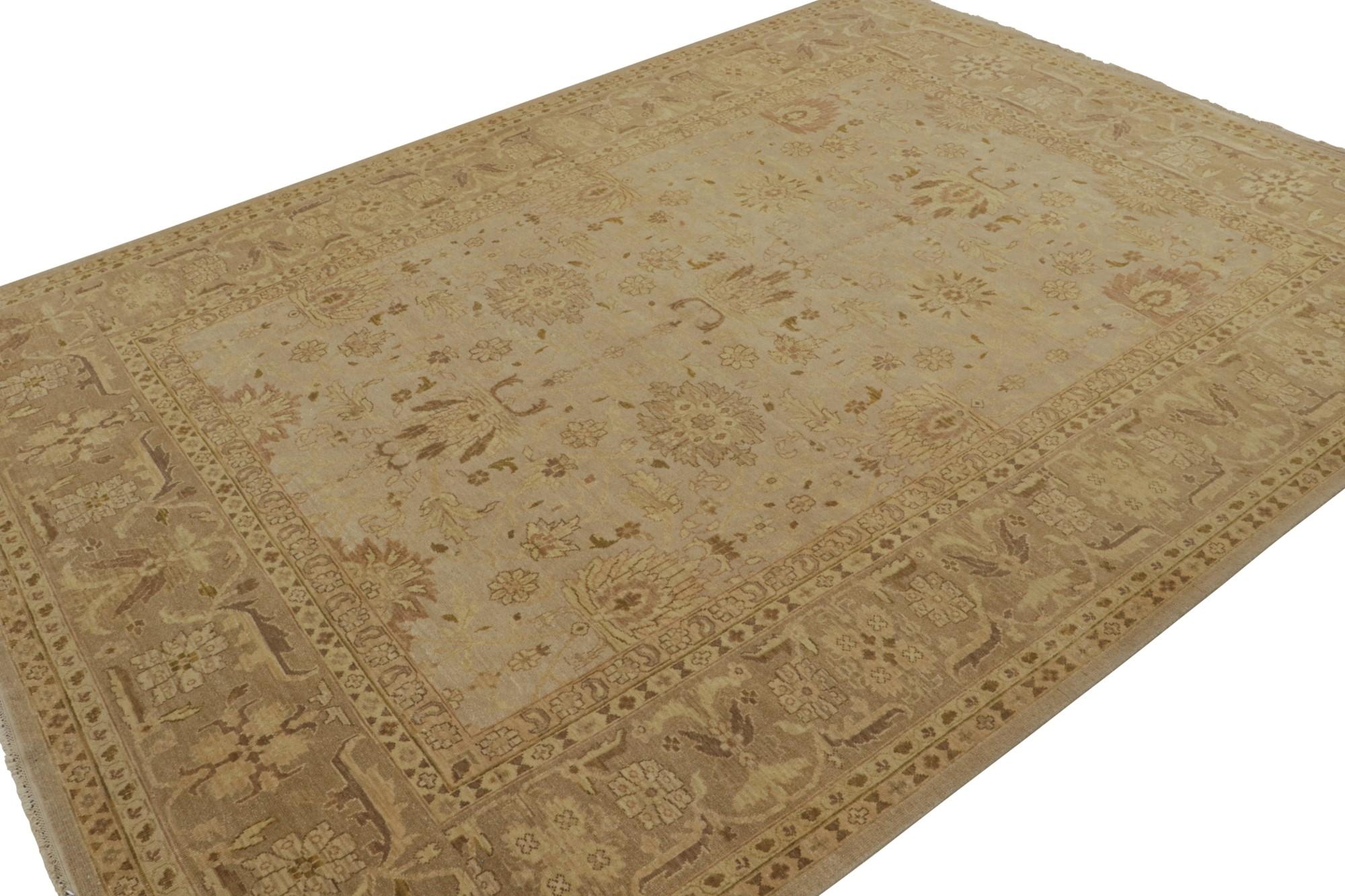 Hand-knotted in wool, this 9x11 rug has been inspired by Persian Mahal rugs. In beige/brown with taupe and gold notes, and subtle pink accents in floral patterns, it is a nod to a time-honored weaving tradition with limitless modern design
