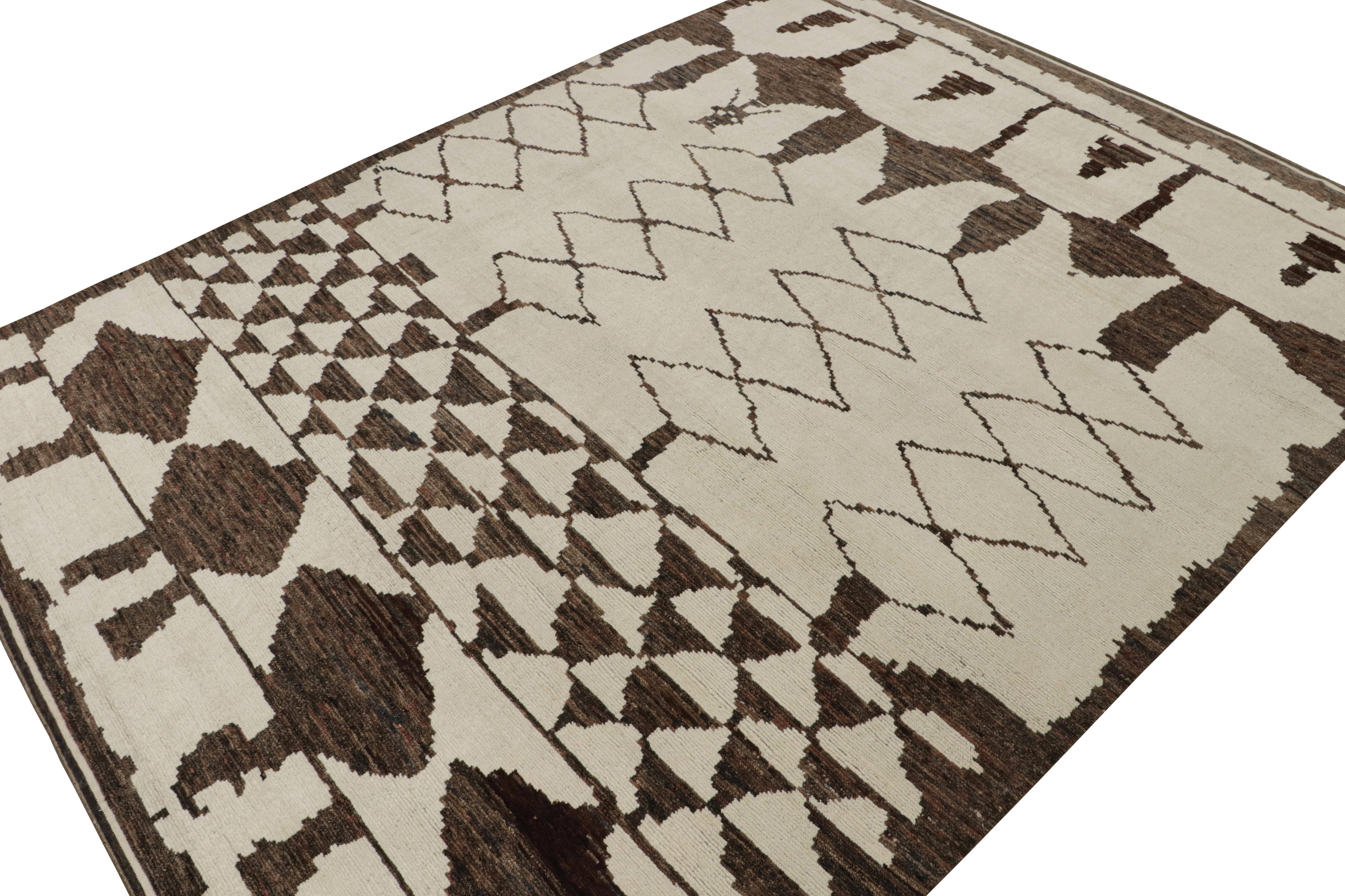 Hand-knotted in wool, this 12x15 rug is a new addition to the Moroccan Collection by Rug & Kilim. 

On the Design

This rug enjoys a cream and beige undertone with chocolate brown lozenges and other geometric patterns of primitivist style.