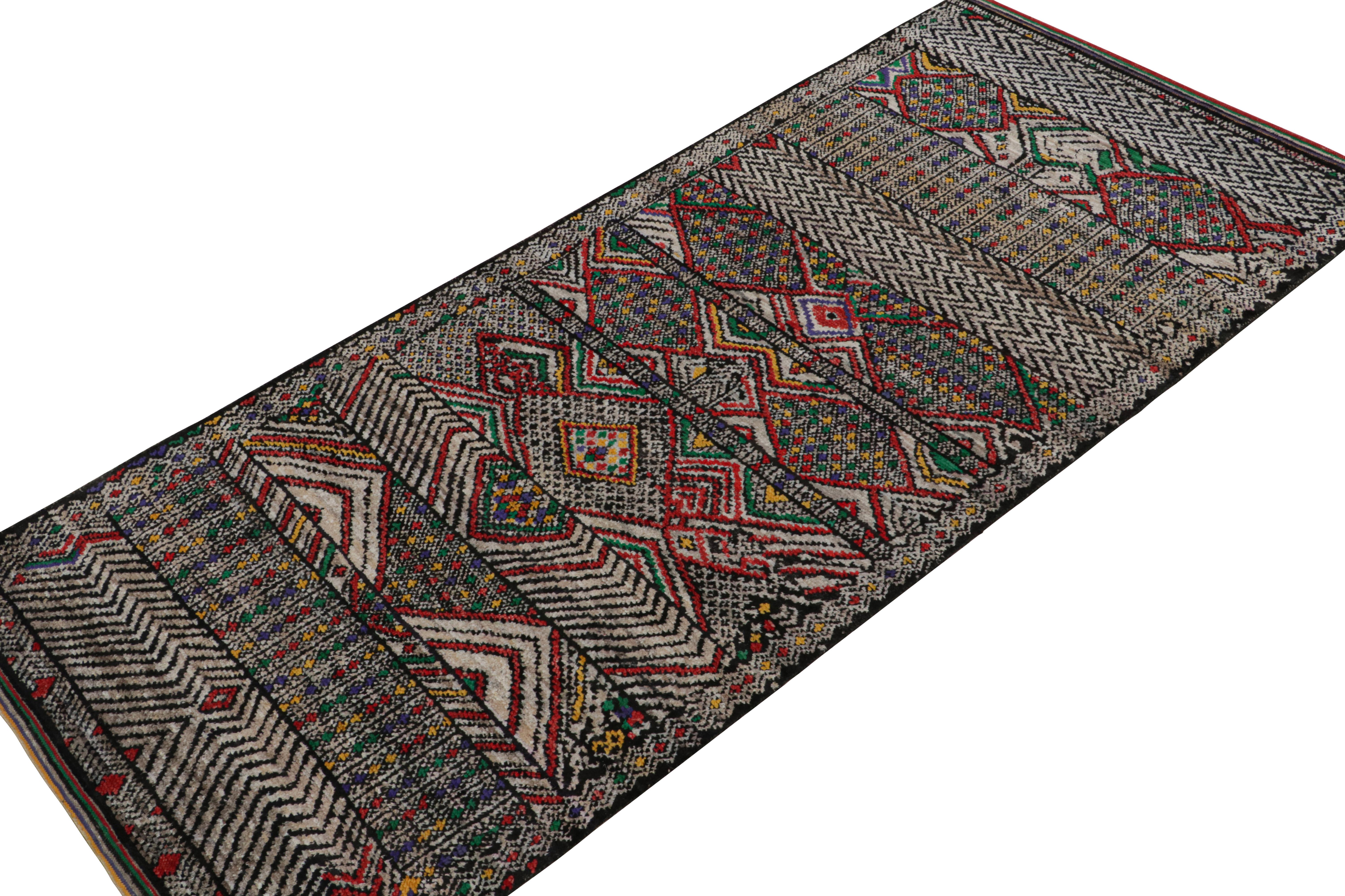 Hand-knotted in wool, silk & cotton, this 5x12 rug is a new addition to the Moroccan Collection by Rug & Kilim. 

On the Design

This rug enjoys primitivist style with patterns in black, gray, red, blue & green. Connoisseurs will admire this as a