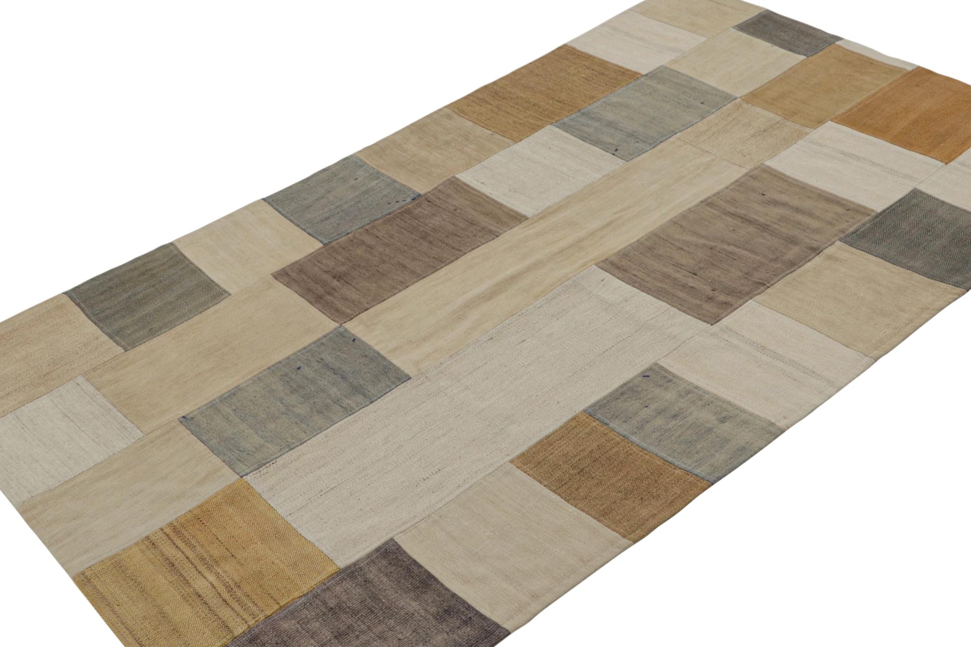 Hand woven in a wool flat weave utilizing vintage yarns, this 4x6 modern Kilim rug from Rug & Kilim’s Patchwork Kilim rug collection marries inspiration from mid-century flat weave rugs with a whimsical spectrum of beige/brown, blue and gray. 

On