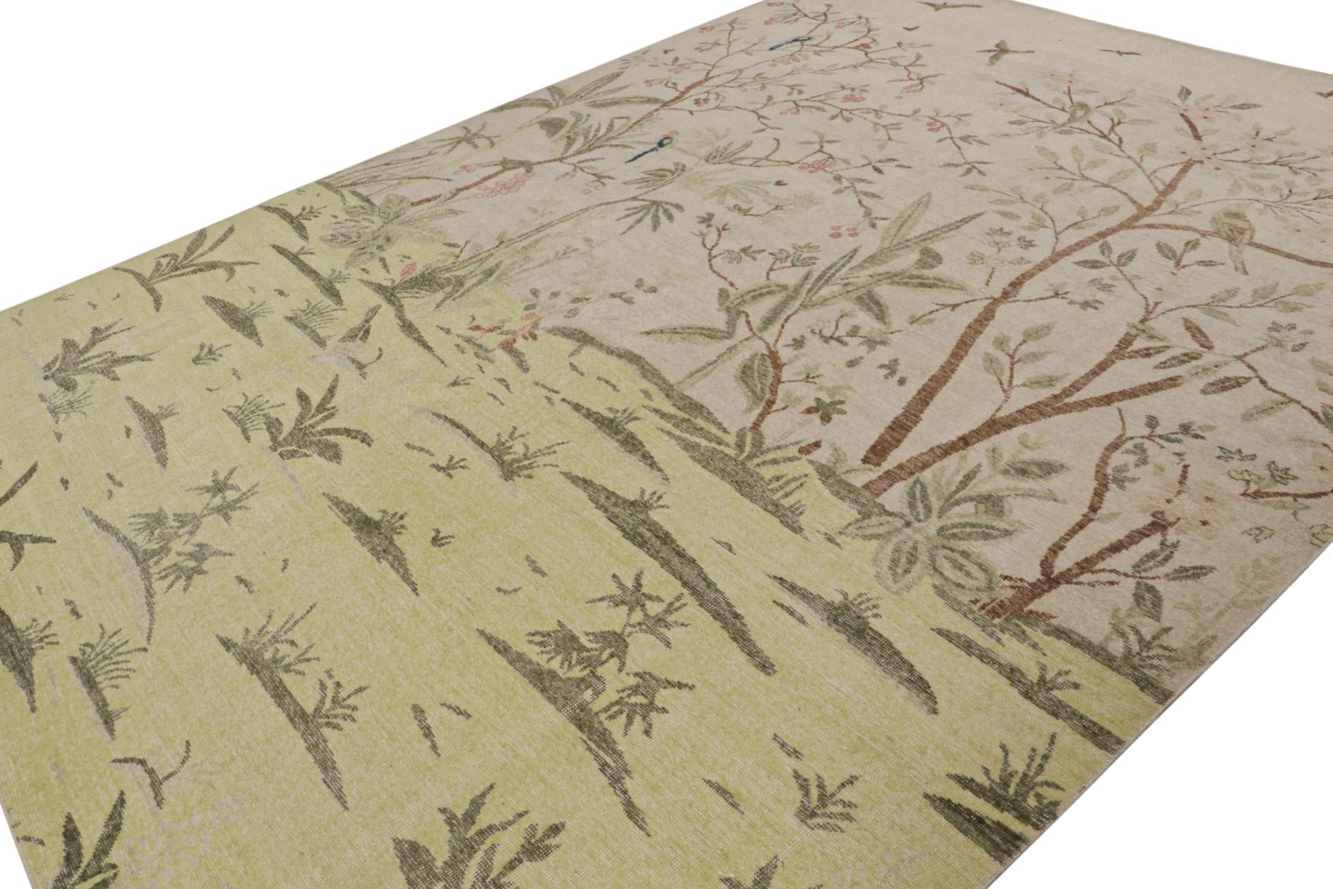 Hand-knotted in wool, this 10x14 modern rug, originating from India, features pictorials of depictions of greenery and birds, in hues of green, pink and taupe. 

On the Design: 

A new addition to the handmade rugs in the modern rug line by Rug &