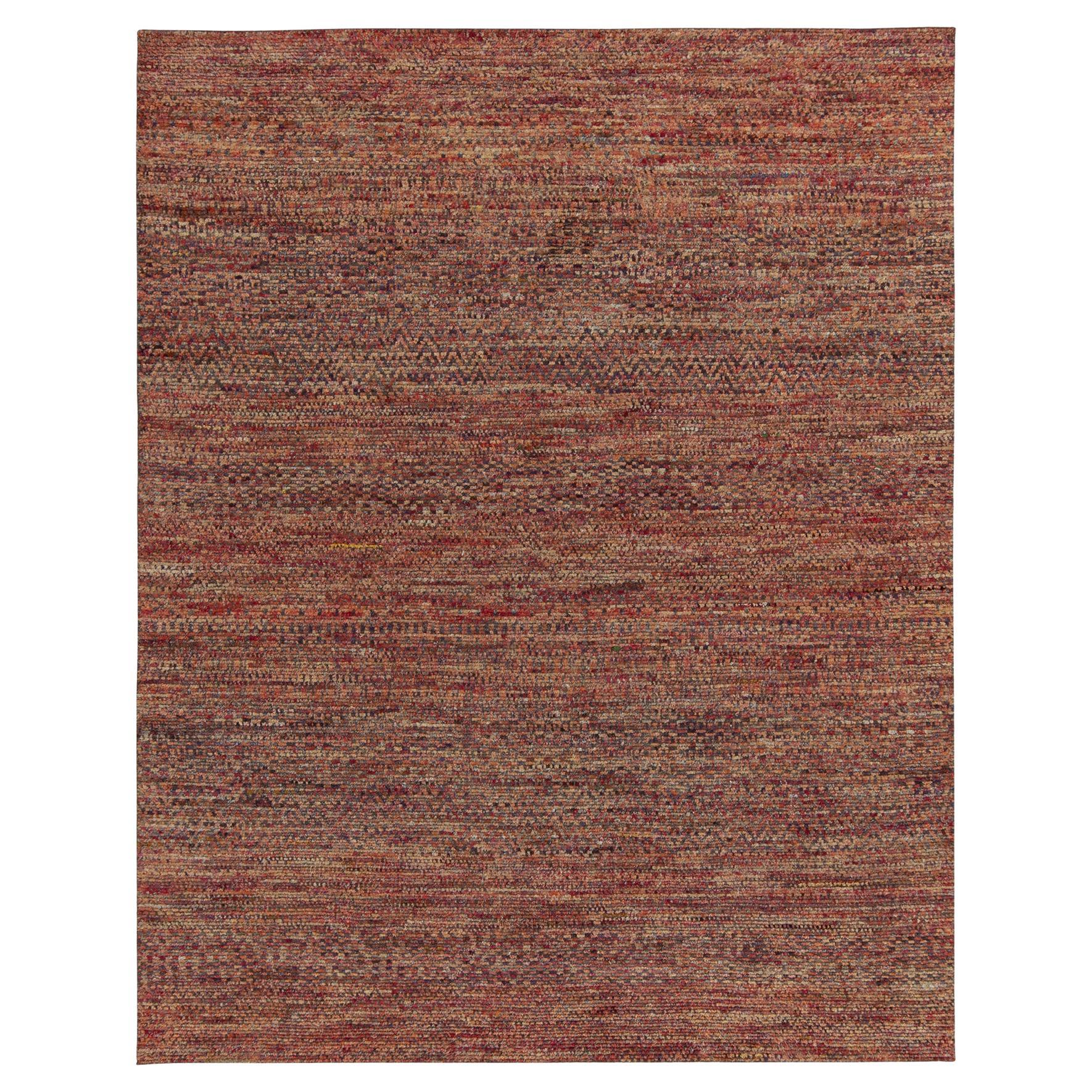 Hand-knotted in luxurious quality silk, a bold 8x10 contemporary rug with exceptional textural element and visual depth. This particular modern design marries striae with subdued geometric patterns in luscious reds, browns, and other warm and robust