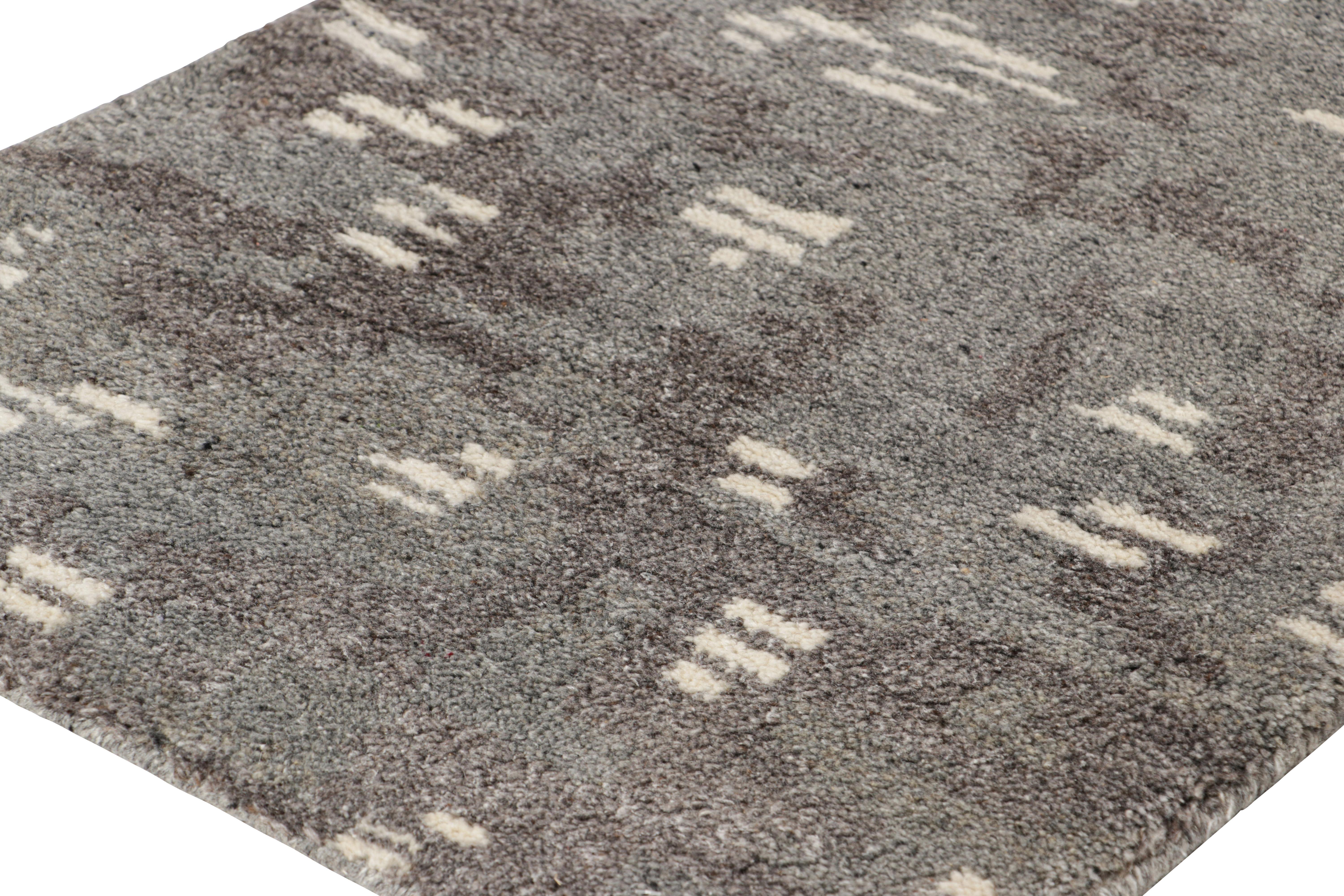 Hand-knotted in wool, this 2x3 modern rug enjoys a cozy, lush pile with an abstract play of subtle color variations and geometric patterns, underscored by charcoal gray, black, and white tones respectively 

On the Design: 

Connoisseurs may admire