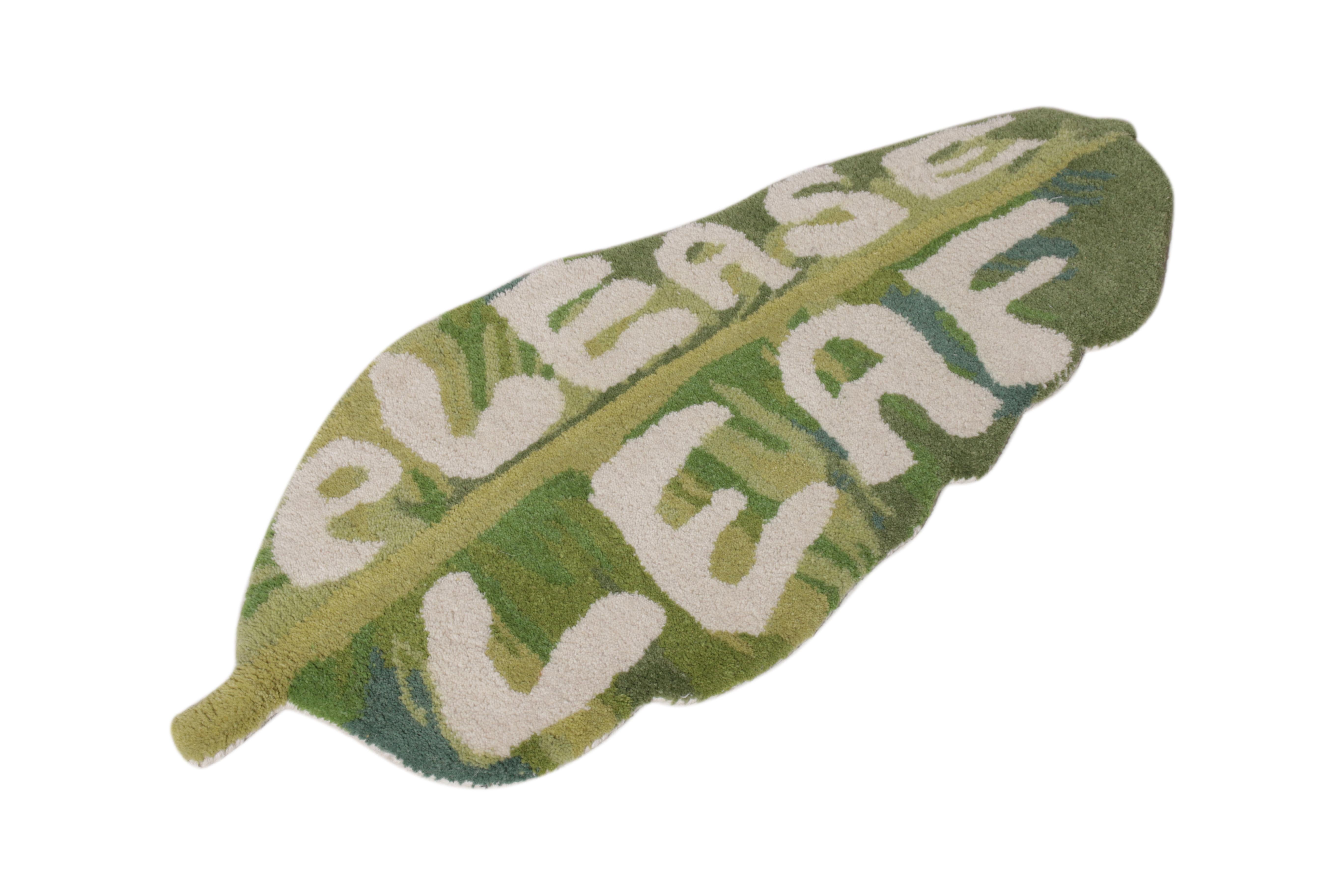 A hand-knotted 1x3 wool rug from Rug & Kilim’s New & Modern Collection. Enjoying high-low text reading “Please Leaf” in playful typography with green and white hues. Ideal as a doormat and accent piece in approachable projects, further sporting a