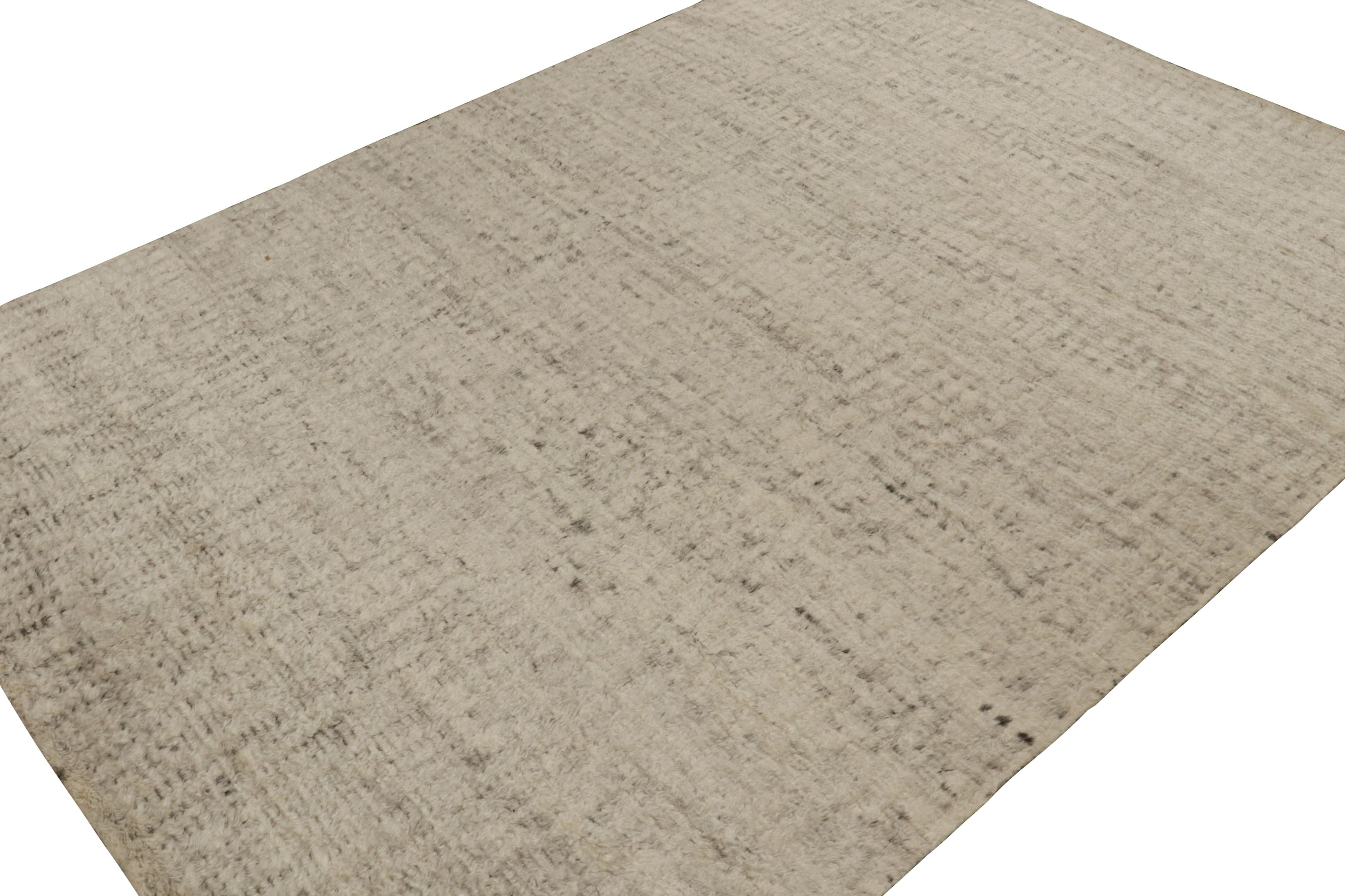 Hand-knotted in wool, this 10x14 modern textural high-pile rug in beige and brown, features a simple design, but extraordinary in its essence to sit comfortably anywhere. 

On the design:

 Embracing simplicity while exuding extraordinary essence,