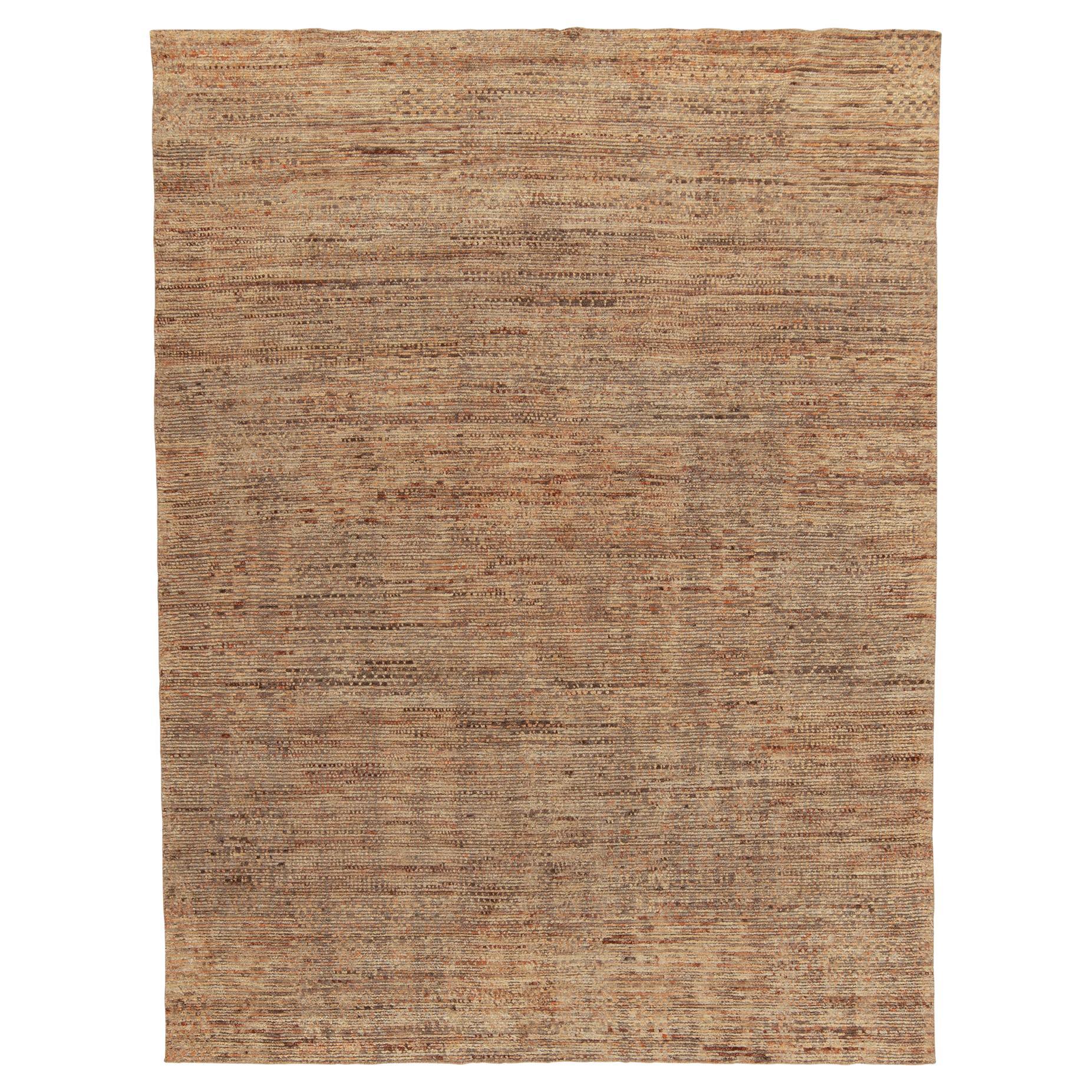 From Rug & Kilim’s Modern selections, an 8x10 hand-knotted piece exemplifying a bold new language in contemporary rugs. The nurtured vision embraces warm striations in orange with subtle kisses of red accenting the richness of beige-brown with a