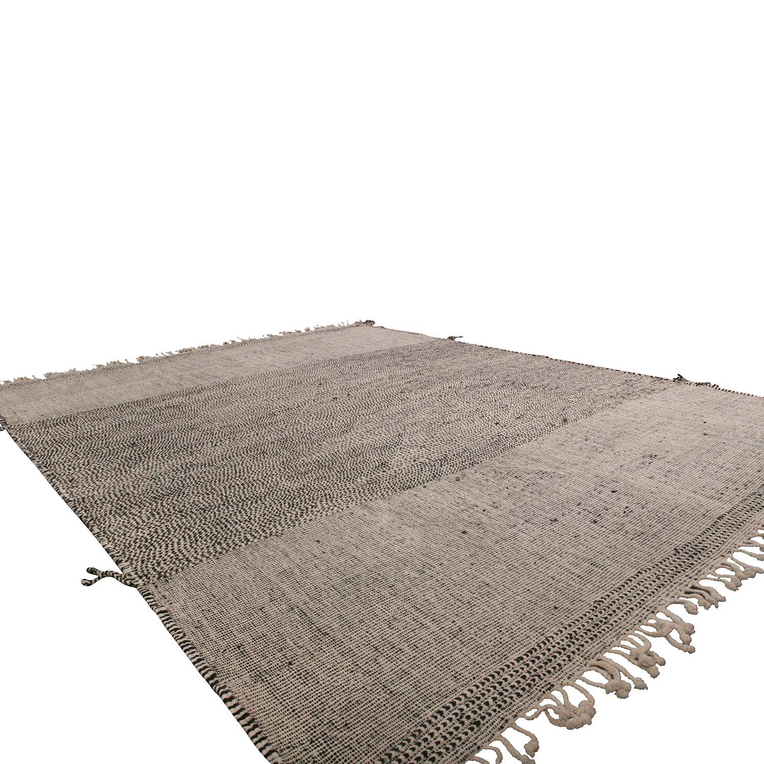 This addition to Rug & Kilim’s extensive contemporary and modern rug collection recaptures the inspiration of a classic Moroccan Berber rug in new large-scale and textural high-low production. The thick braiding at the playful fringes, borders and