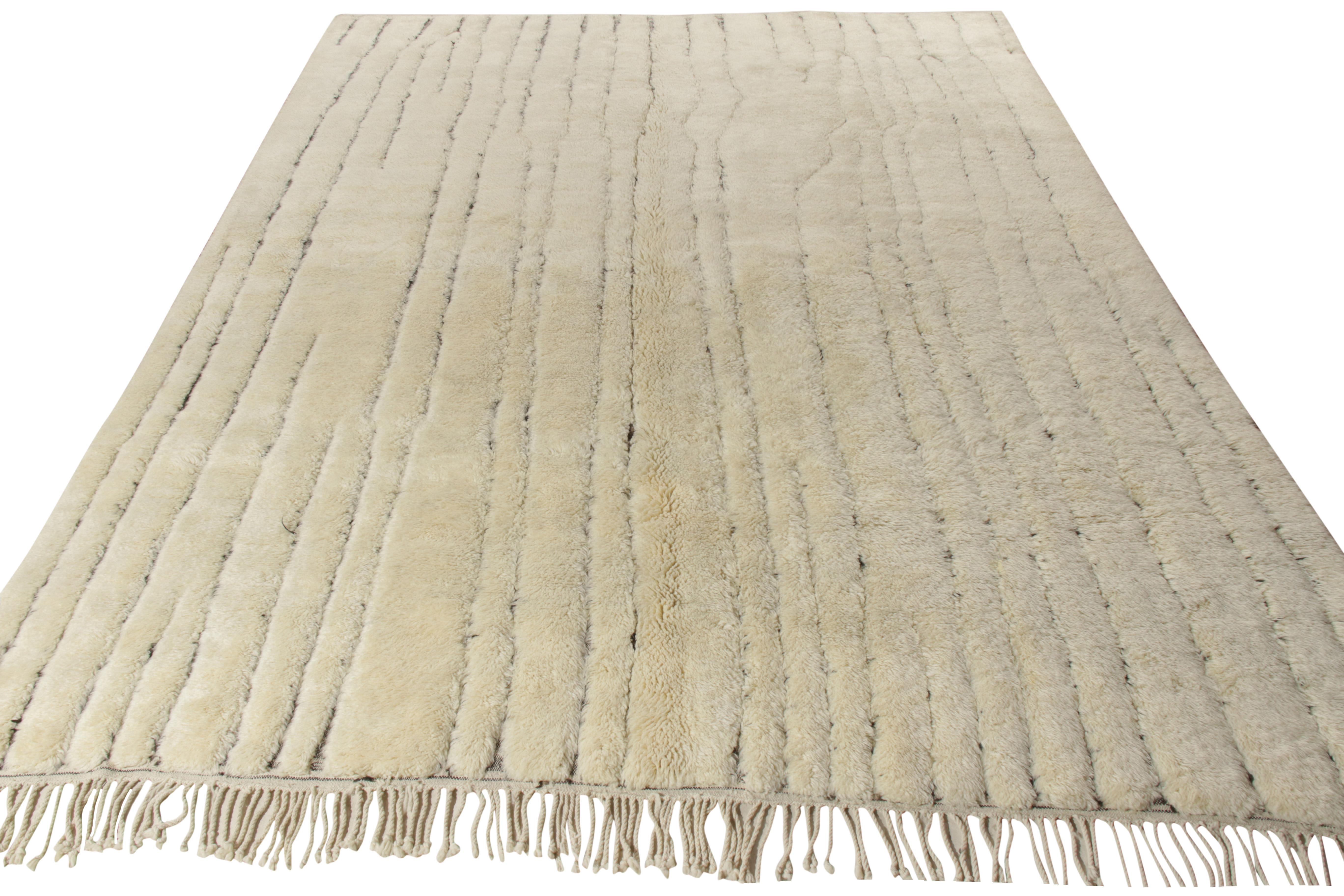 A 10x13 hand-knotted ode to Berber rugs from Rug & Kilim’s contemporary Moroccan rug collection. Donning a sophisticated look, the rug enjoys a minimalistic geometric pattern in a luscious combination of off-white and black playing fabulously with