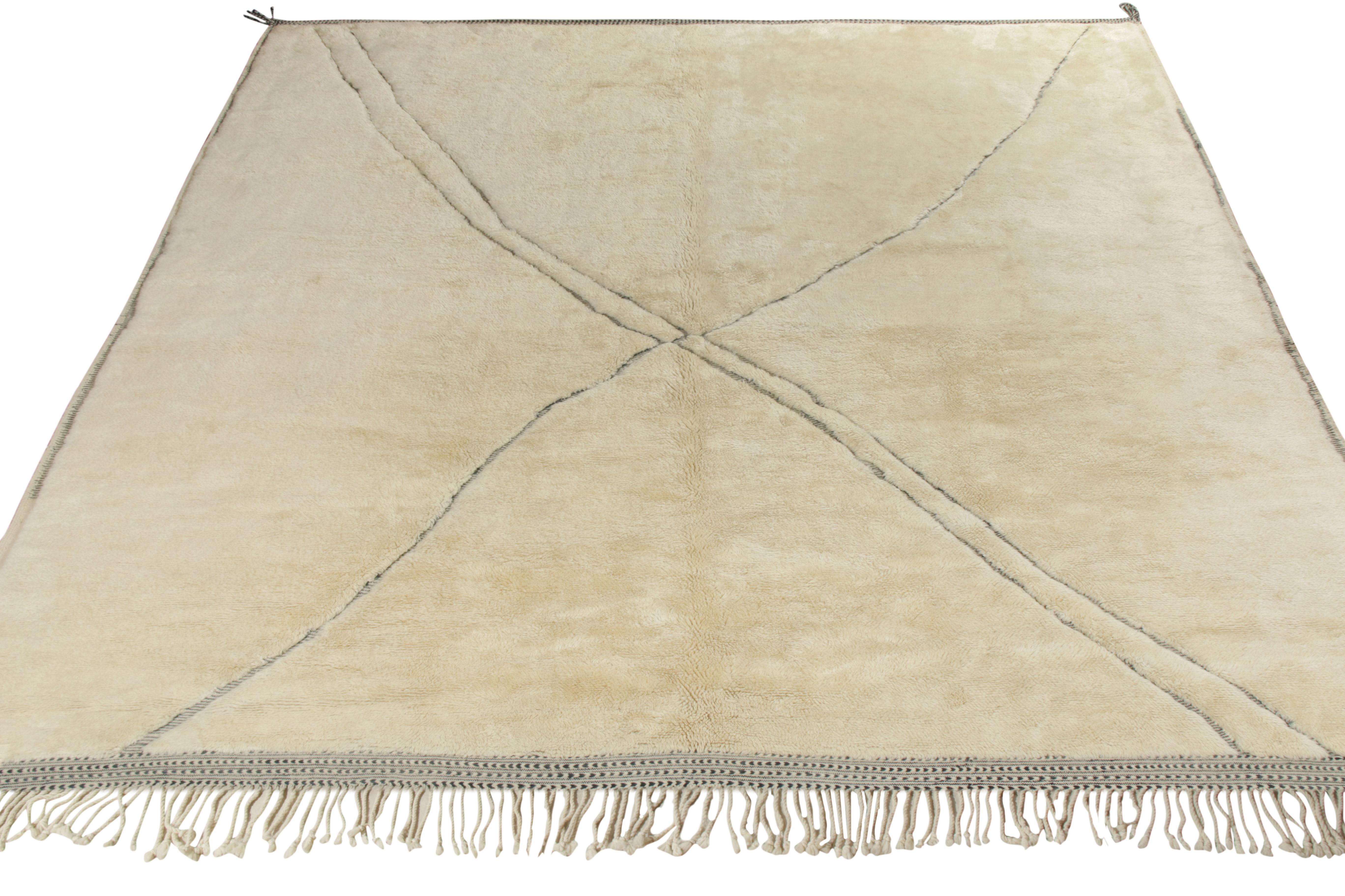 Hand knotted in quality wool, a contemporary custom design from Rug & Kilim’s Moroccan rug collection. Exemplified in this 13x13 edition, while the field revels in the exuberance of a creamy beige-white colorway, the rug enjoys a sophisticated look